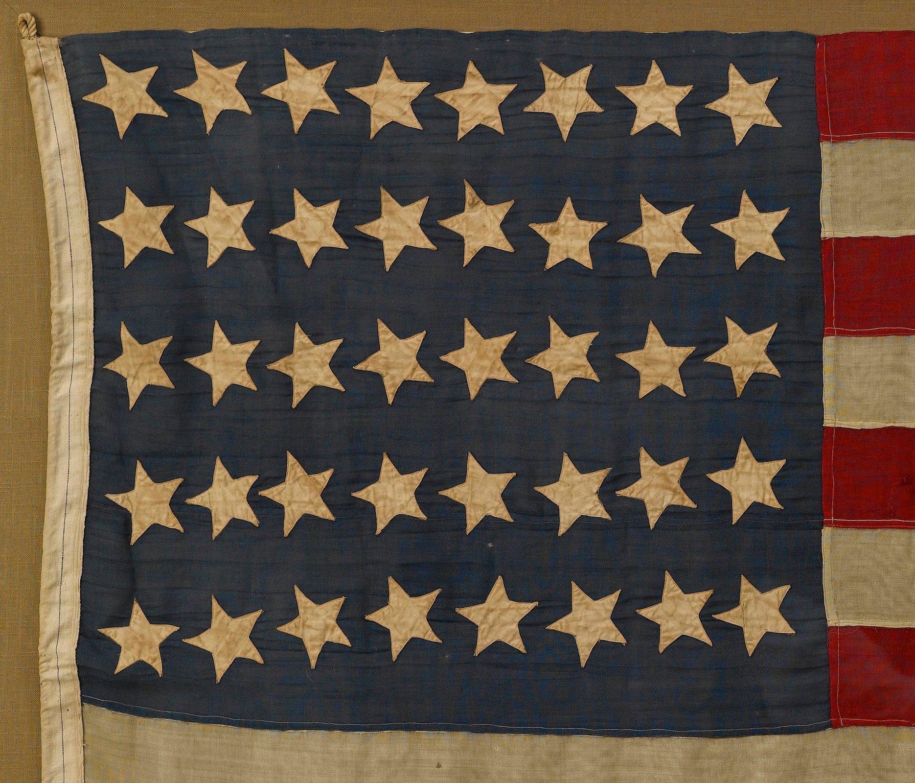 This 40-star American flag is very rare and celebrates the addition of North and South Dakota to the Union. 

The body of the flag is constructed of wool, with 40 machine-sewn, double-applique cotton stars configured in 8/8/8/8/8 horizontal rows.