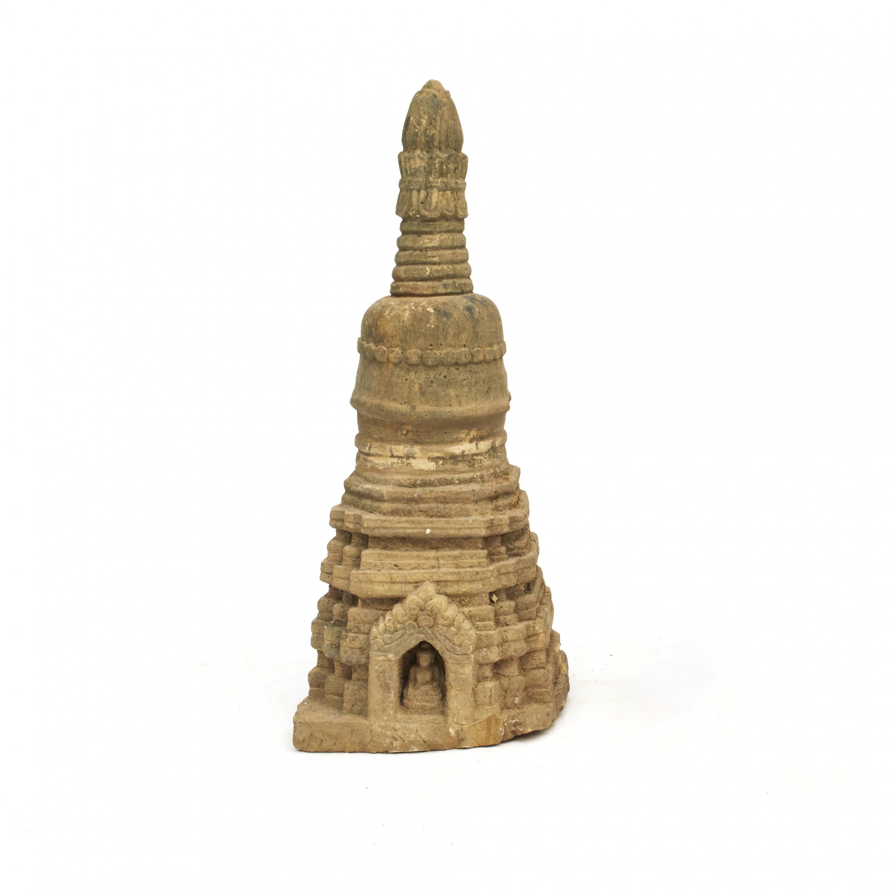Rare stupa sculpture, 400-600 years old, carved in sandstone. In original untouched, well-preserved condition. From Arakan in Burma.
Typical stupa construction with square base, hemispherical dome and conical spire.
At the base a portal door with
