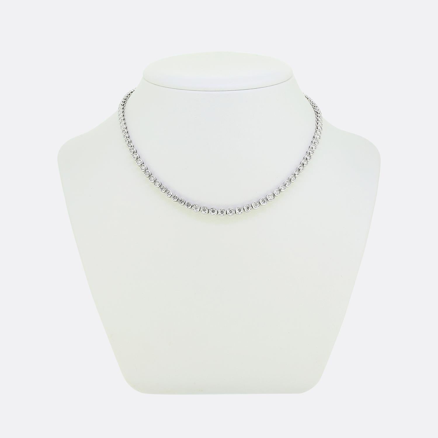 Here we have a classically styled diamond line necklace. This contemporary piece has been crafted from 18ct white gold and showcases a continuous line of bright white round brilliant-cut diamonds; each of which has been individually bezel set whilst