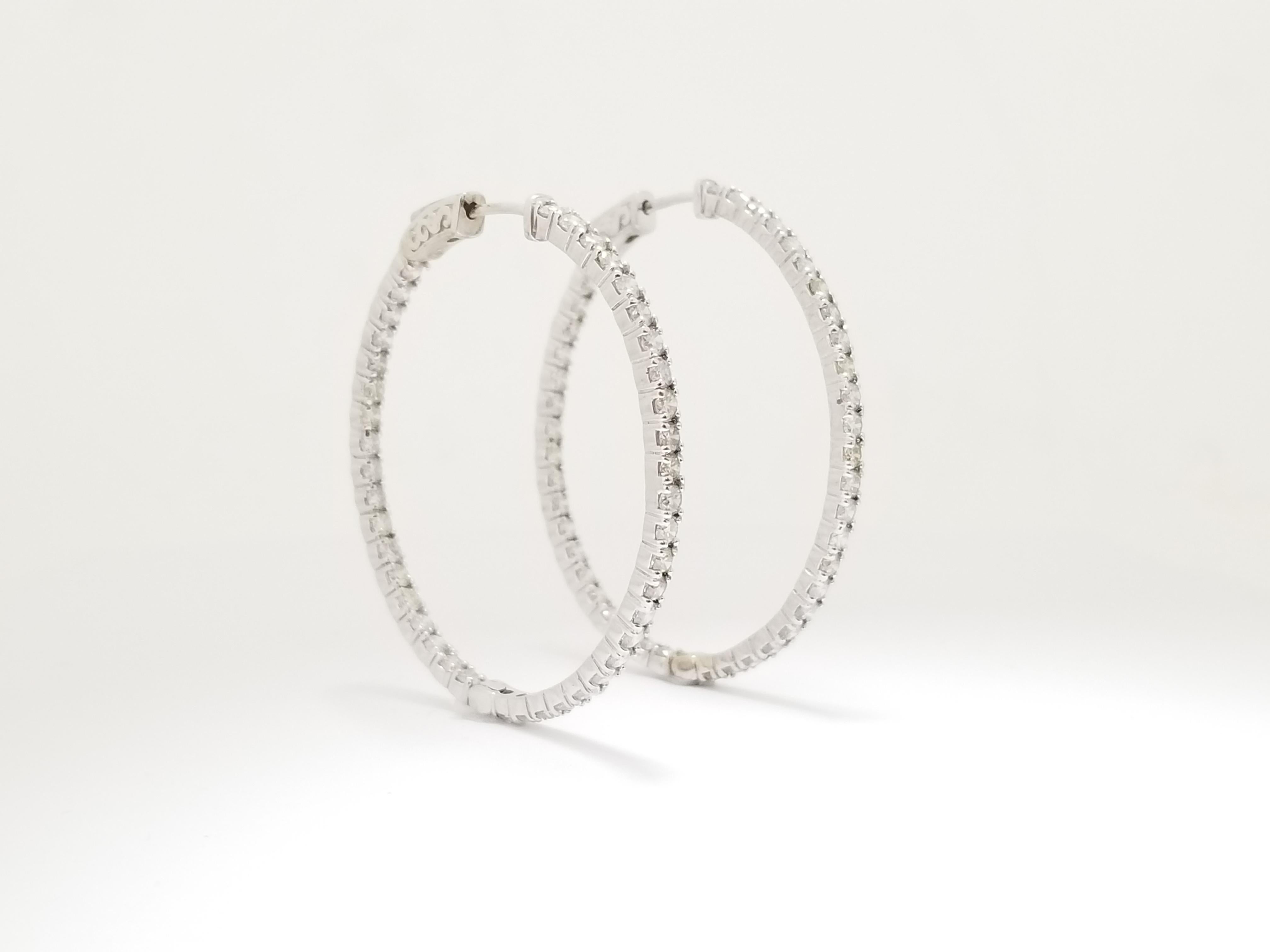 Beautiful pair of natural diamond oval inside out hoop earrings in 14k white gold. Secures with push snap closure. Very shiny and clean, average I-J, Color, VS-SI Clarity,  Perfect for the everyday wear! Measures 1.65 inch x 1.40 inch .
