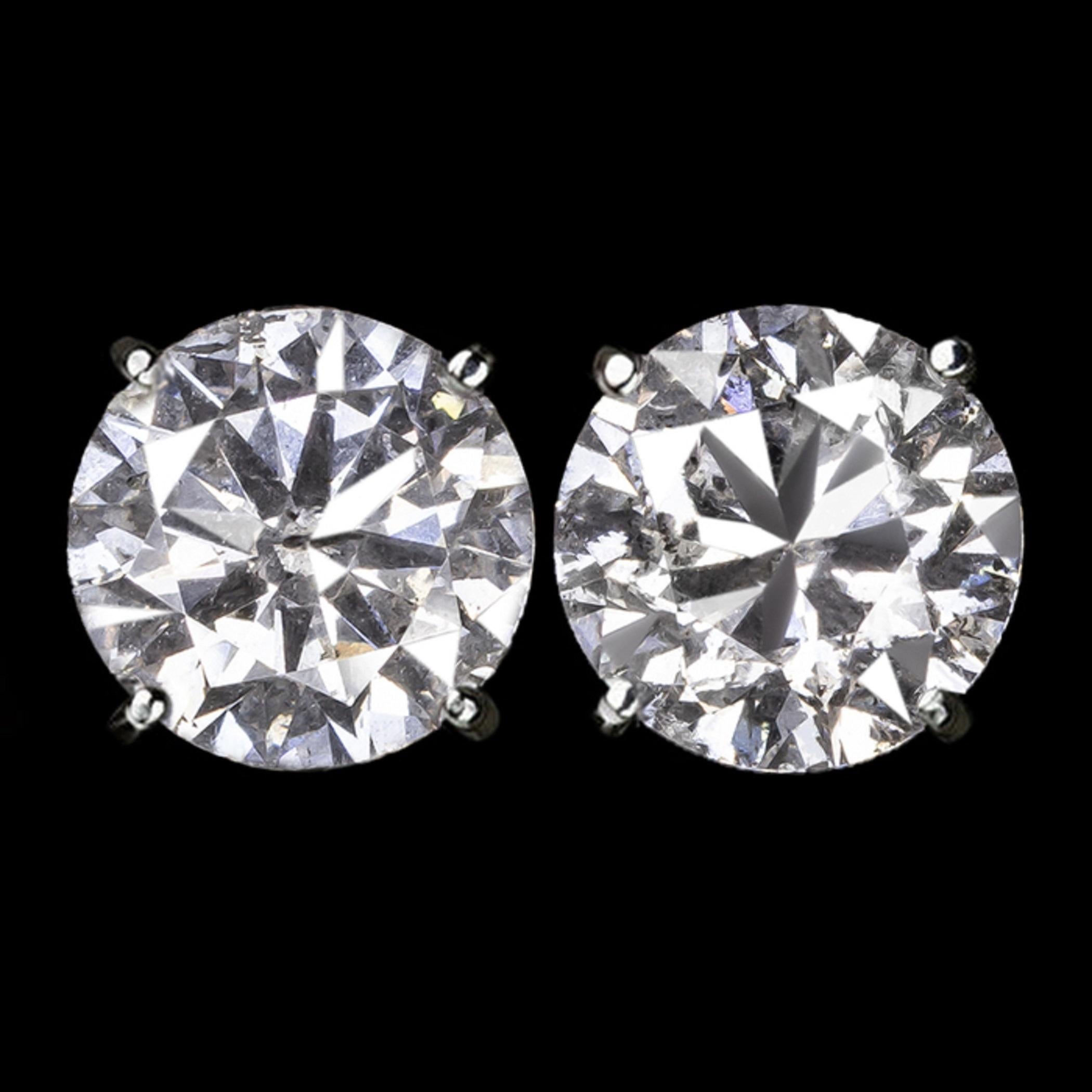 This stunning 4 carat pair of round brilliant cut natural diamonds have bright white color, impressive size, and lovely sparkle! These beauties are offered at a considerable value for their size! They are 100% natural earth mined diamonds and have