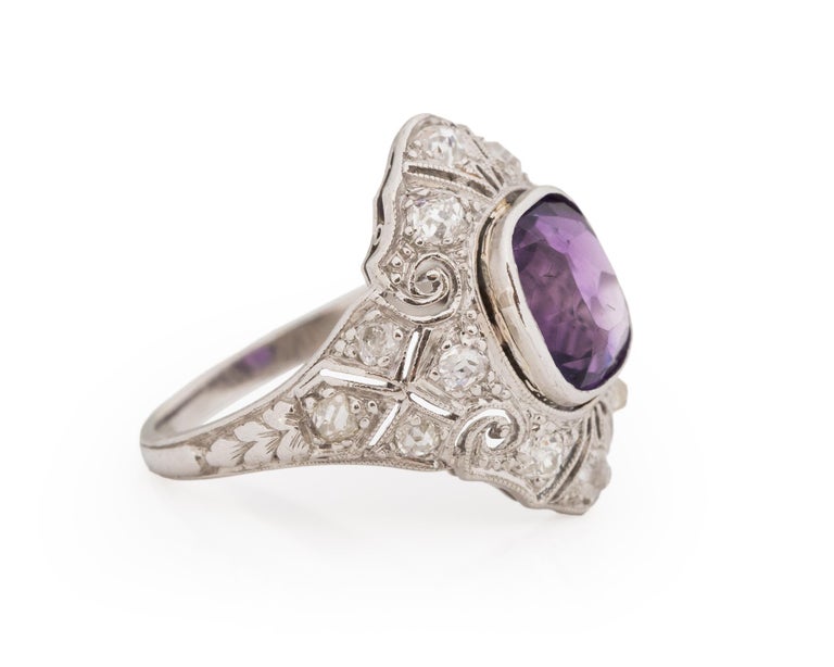 Ring Size: 6.25
Metal Type: Platinum [Hallmarked, and Tested]
Weight: 7.8 grams

Center Stone Details:
Type: Amethyst
Weight: 4.00ct
Cut: Antique Cushion
Color: Purple

Side Stone Details:
Weight: .60ct, total weight
Cut: Old Mine Cushion
Color: