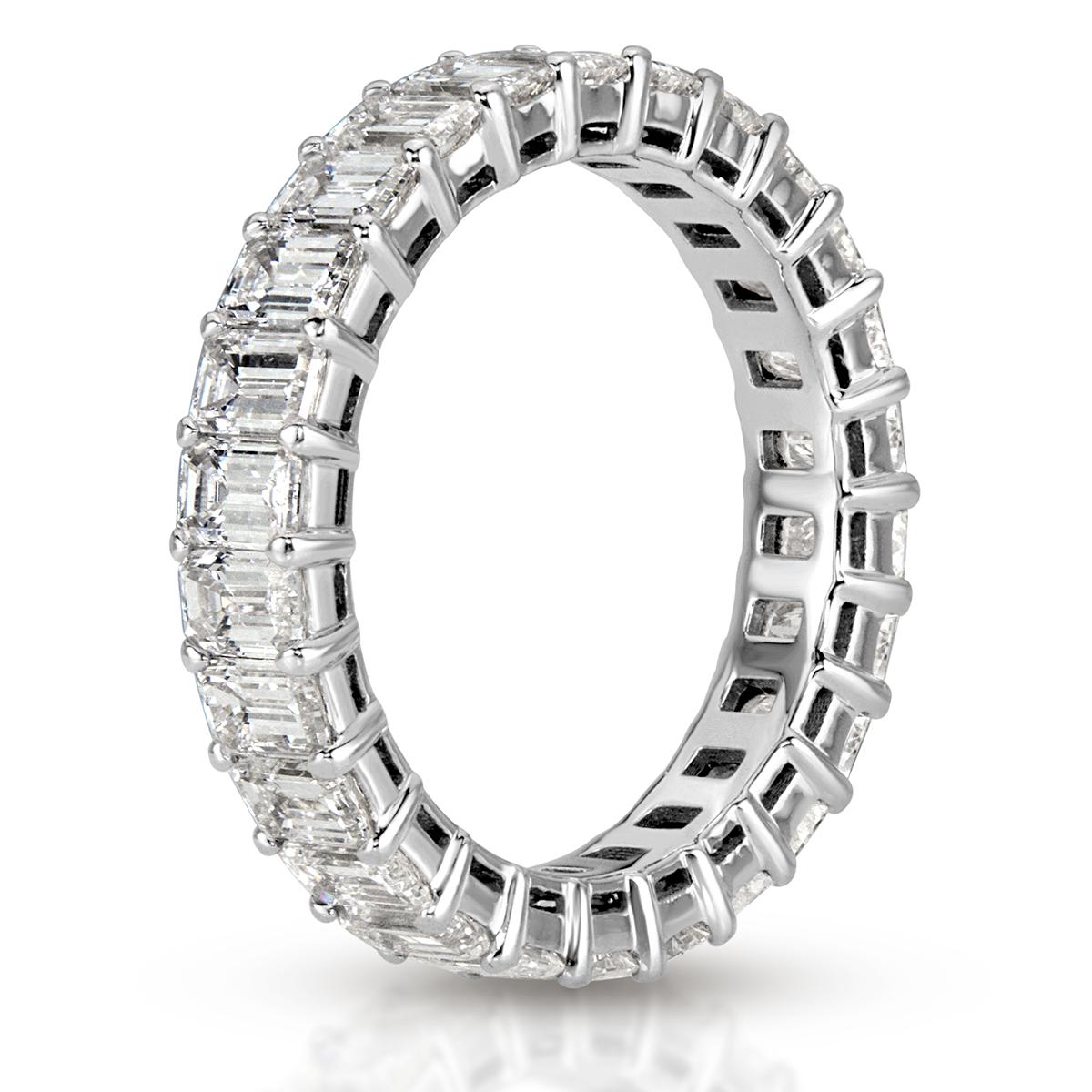 This elegant diamond eternity band showcases 4.00ct of perfectly matched emerald cut diamonds graded at F-G in color, VS1-VS2 in clarity . The diamonds are hand set in a classic 18k white gold, basket setting style. All eternity bands are shown in a