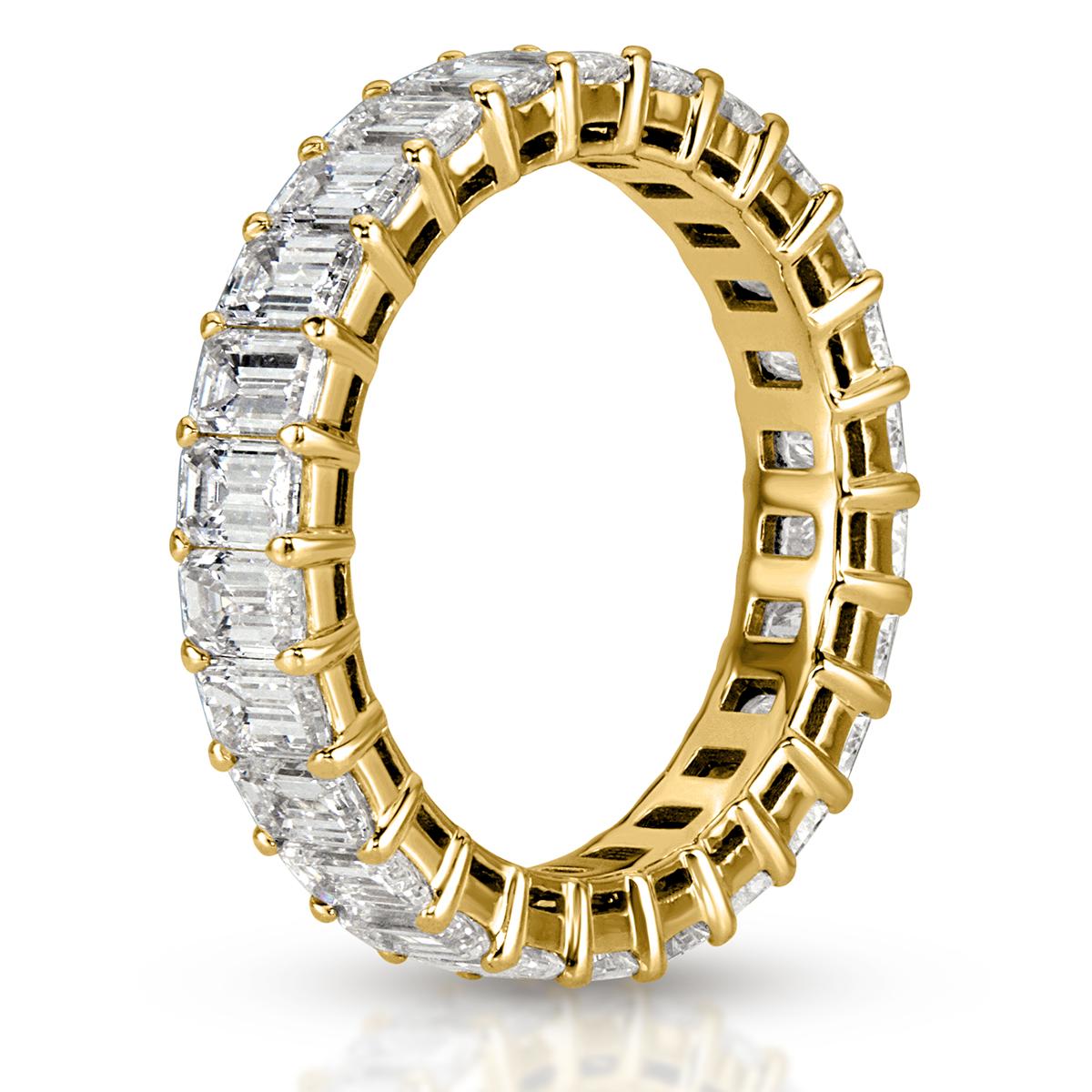 This gorgeous diamond eternity band showcases 4.00ct of perfectly matched emerald cut diamonds graded at F-G, VVS2-VS1. The diamonds are hand set in 18k yellow gold. All eternity bands are shown in a size 6.5. We custom craft each eternity band and