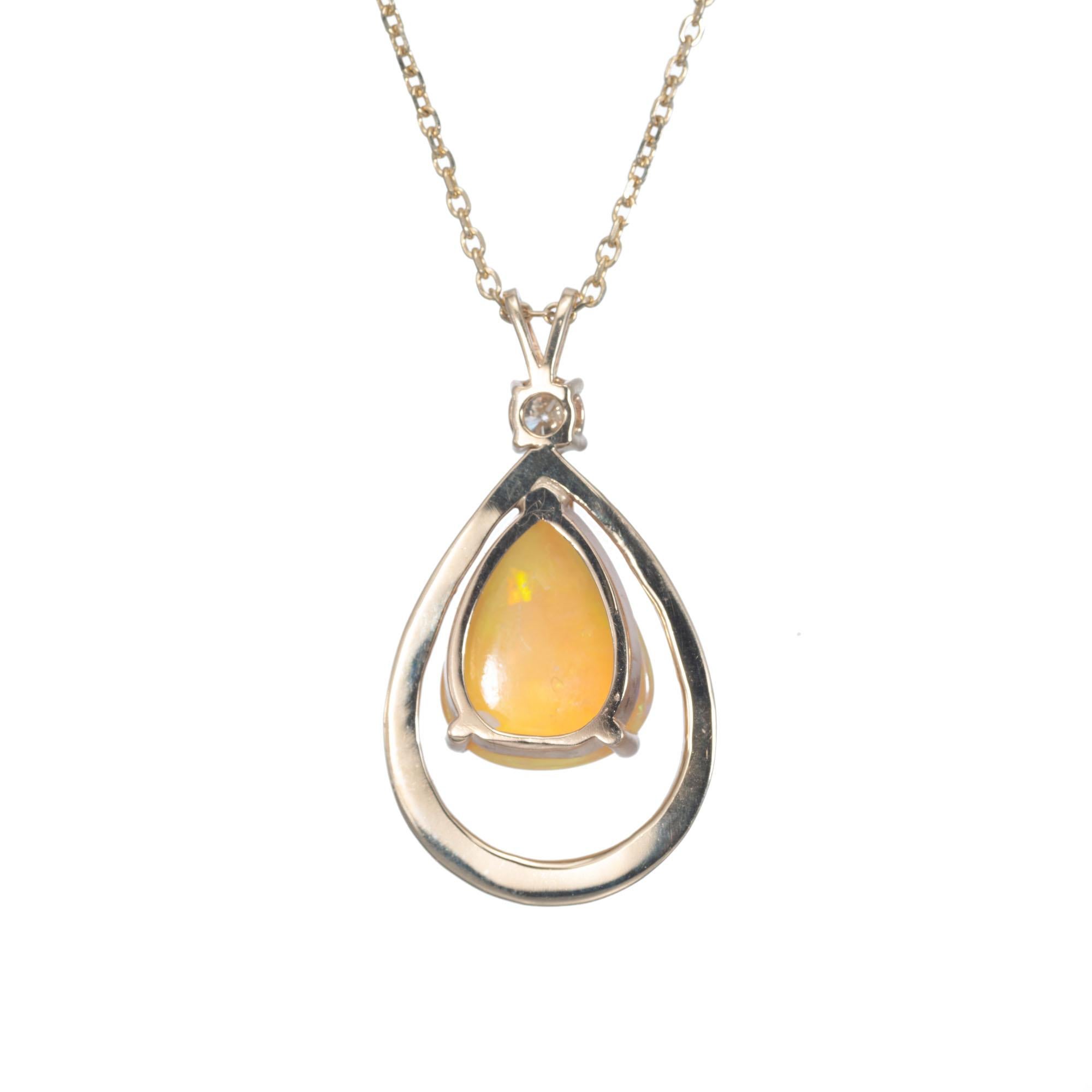 Orange yellow green translucent pear-shaped opal in a brushed pear shape 14k yellow gold setting, with a .20 round accent diamond. 18 inch chain

1 pear shape orange yellow green opal, approx. 4.00cts
1 round brilliant cut diamond J, SI2, approx.