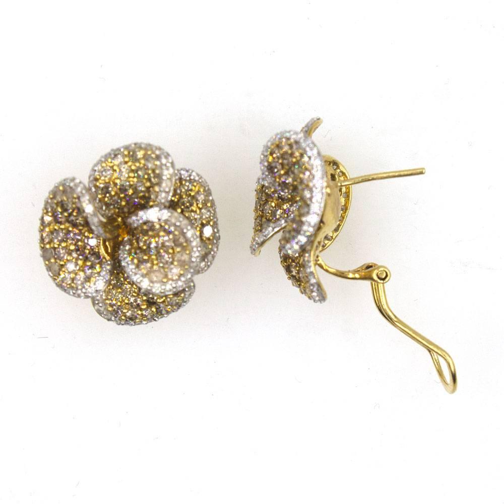 These stunning earrings fashioned in two tone 18 karat gold feature white and champagne color diamonds. The floral earrings are set with 4.00 carat total weight of diamonds. The earrings measure 20 x 20mm and weigh 13.5 grams. 