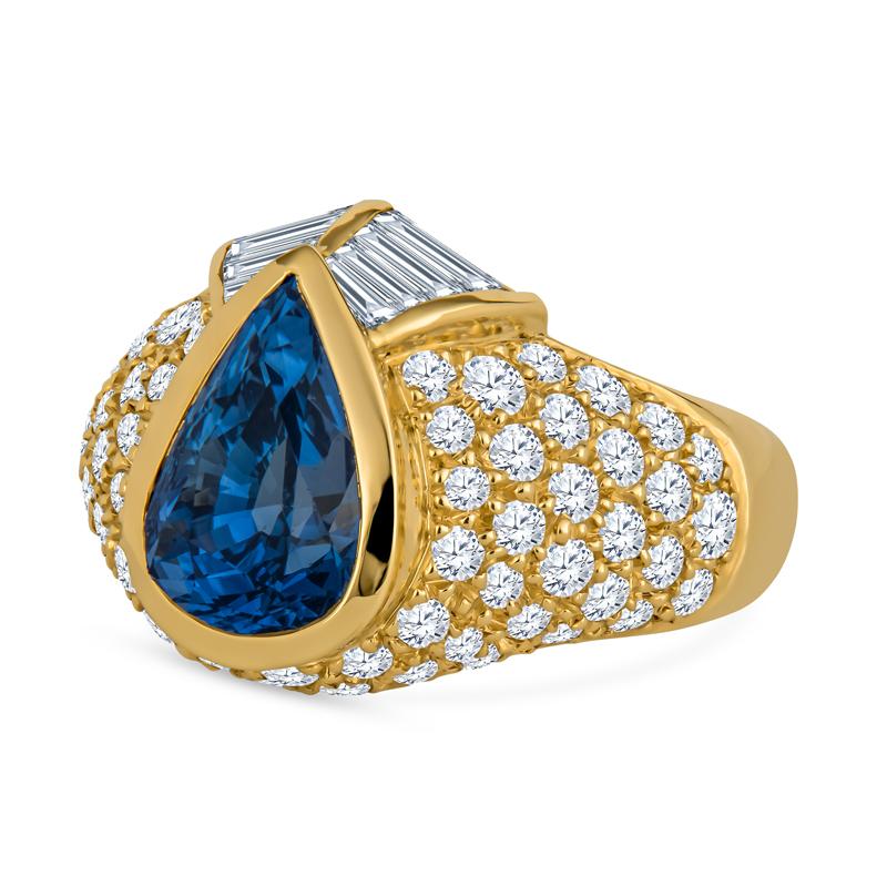 This stunning pear shaped Sri Lankan blue sapphire and diamond ring features an approximately 4.00 Carat pear shaped Sapphire  with six mixed baguettes set around the point like a cascading Chevron weighing approximately 0.73 carats and a scatter of