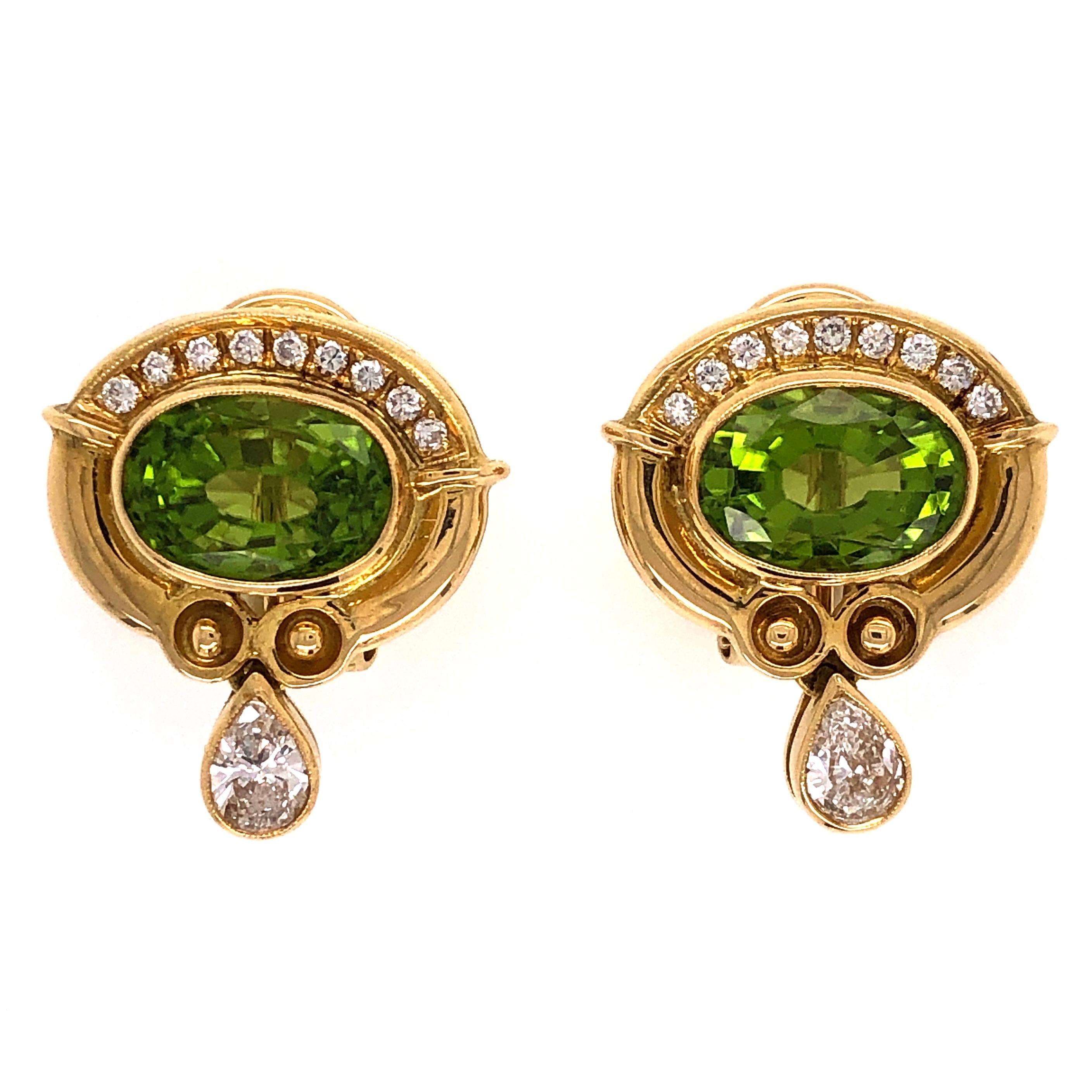 Simply Beautiful and finely detailed Earrings, center securely set with a Peridot, weighing approx. 4.00 Carats and measuring approx. 19mm x 17.4mm, accented by Diamonds, approx. 0.75 total carat weight. Hand crafted 18 Karat yellow Gold handmade