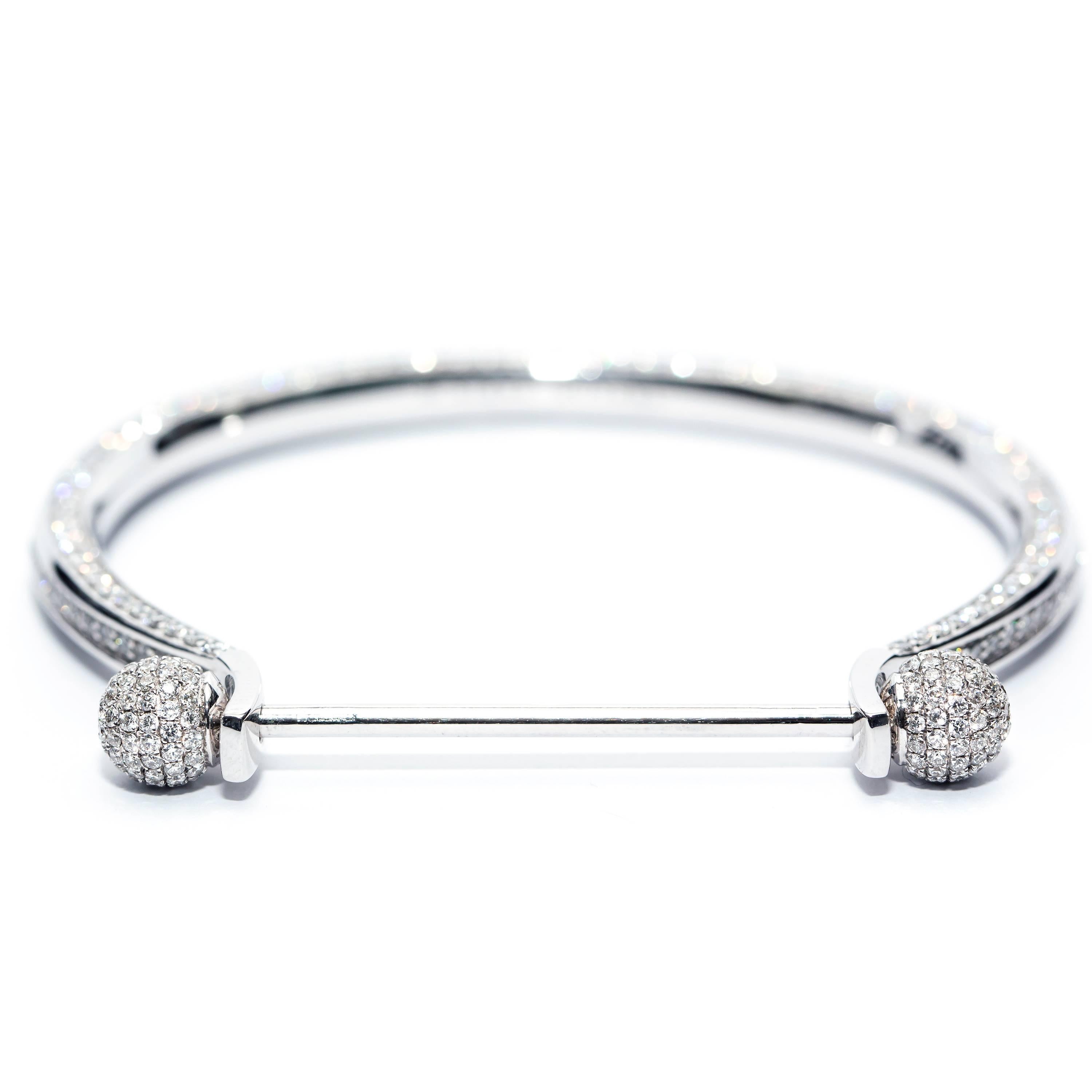 This deluxe Eternal Bangle crafted in 4.00 Carats of H -SI1 Round Diamonds for a heavy weight luxury feel featuring sphere ends on a screw fix bar which enables you to add charms and interchange the end fittings. Set in 18 Karat White Gold to create