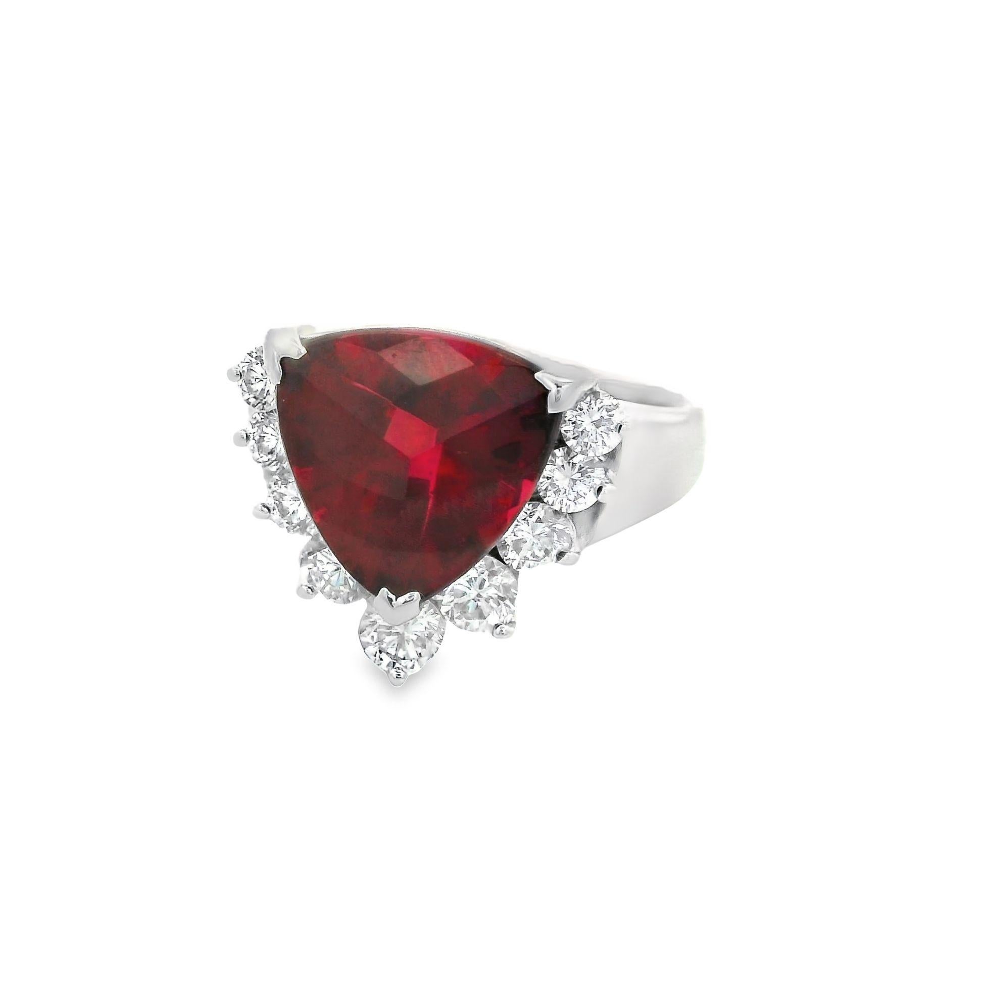 A super fine rubellite tourmaline, weighing 4.00 carats, with an intense vivid red color takes center stage! It has a unique triangular-shape and is complemented by 0.80 carats of round brilliant-cut diamonds. The diamonds graduate in size and are