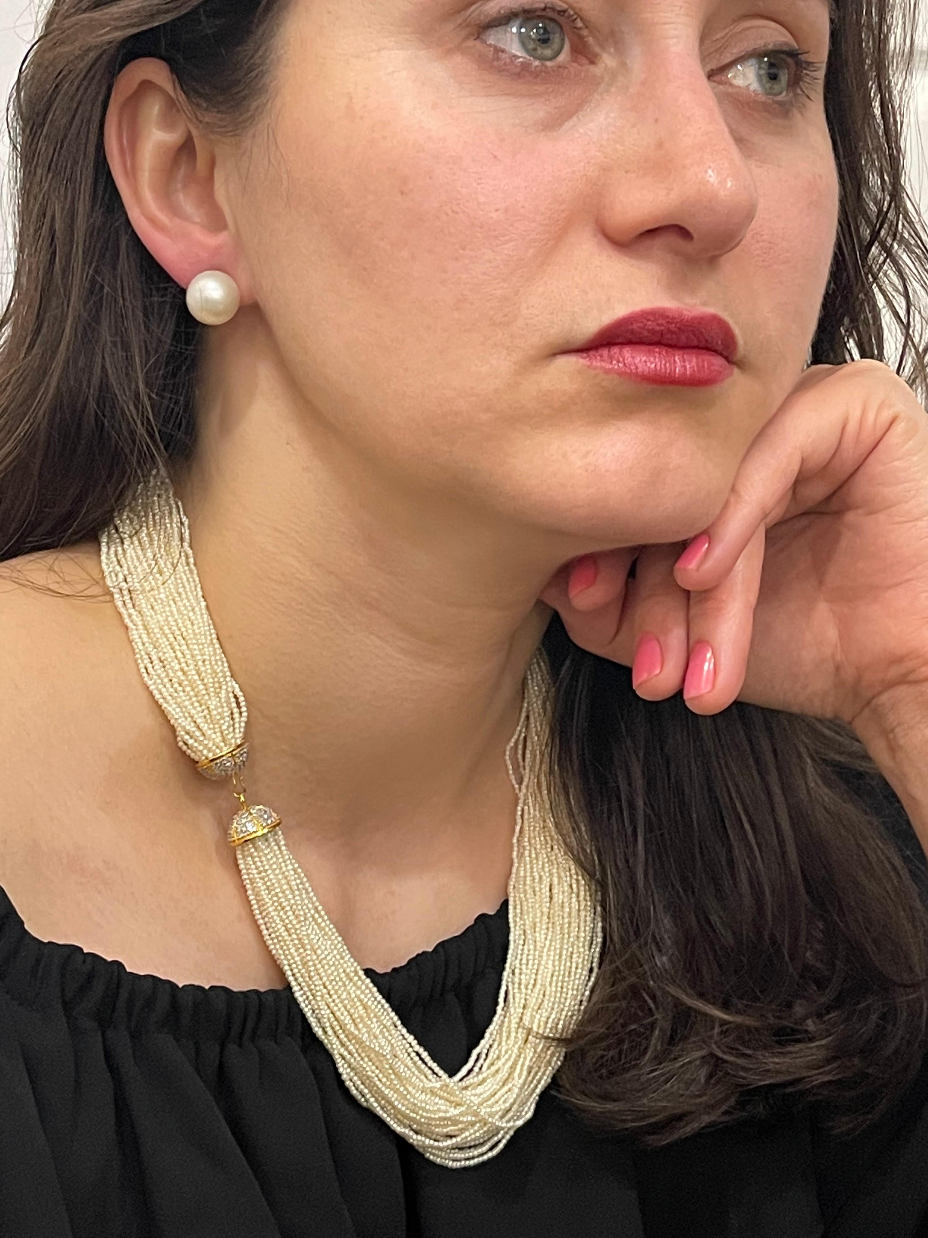 Stunning Necklace  composed of 43  strands of seed pearls ( average 2mm in size ,well matched, of cream body color with faint rose overtones. They are of good quality and luster. The strands are ending in a cap made of diamonds and yellow gold.
This
