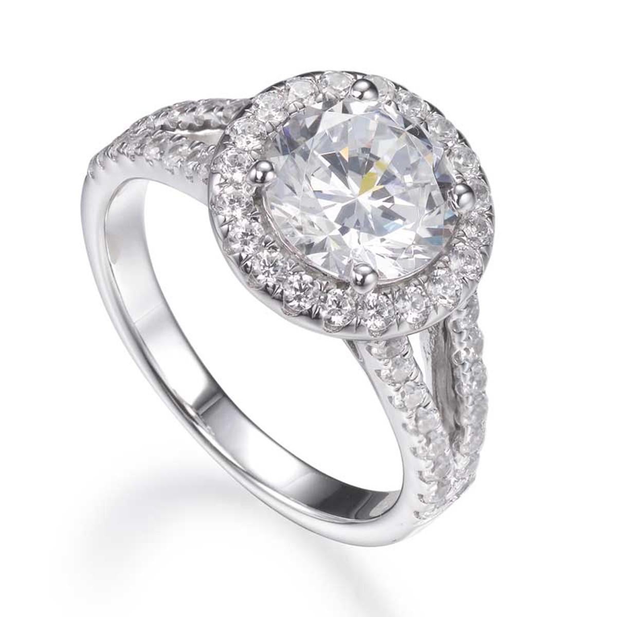 The sparkling halo and split shank setting encrusted with diamond stimulants, draws the eye to the magnificent 4.00 carat centre round brilliant cut cubic zirconia. 

Composed of 925 sterling silver with a high gloss white rhodium finish.

Whether
