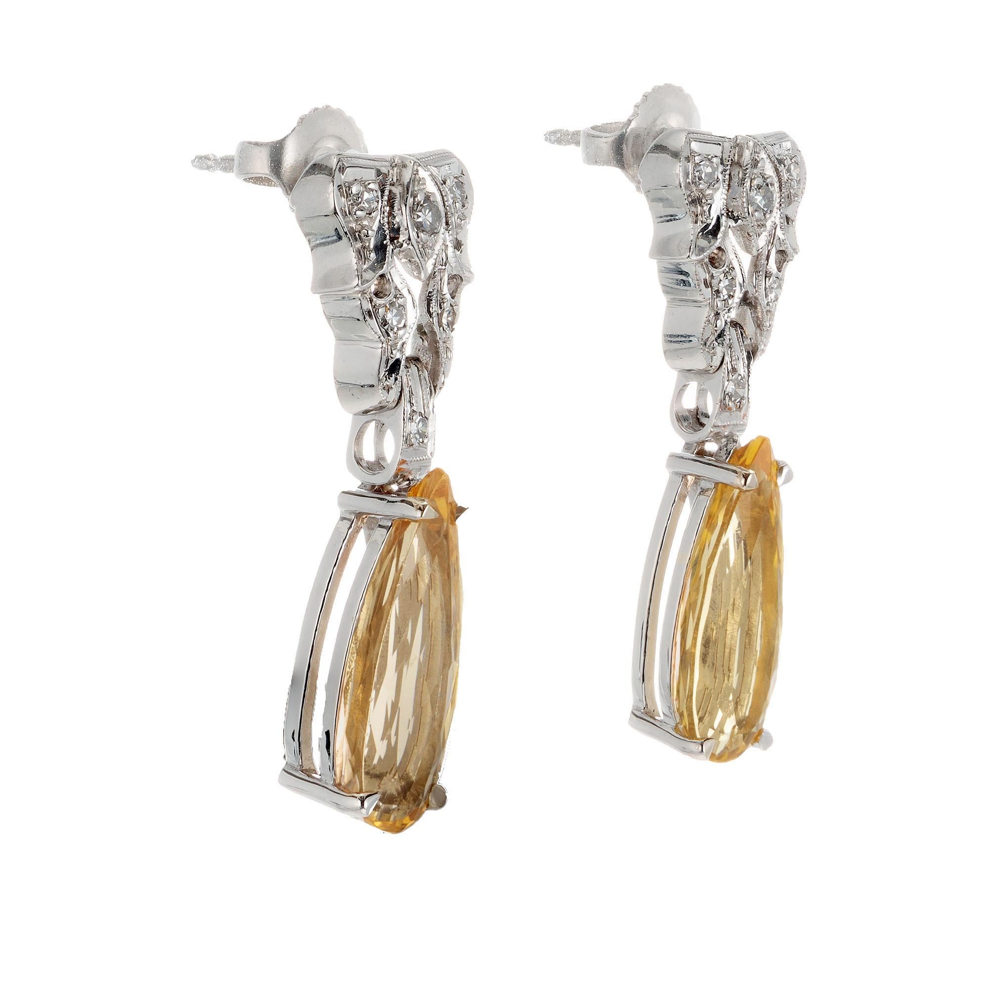 Vintage topaz and diamond dangle earrings. 4.000 carat pear shape precious topaz yellowish orange dangles with 14k white gold single cut diamond tops. Natural untreated topaz. circa 1950's

2 pear shape yellowish orange topaz VS, approx. 4.00cts
12