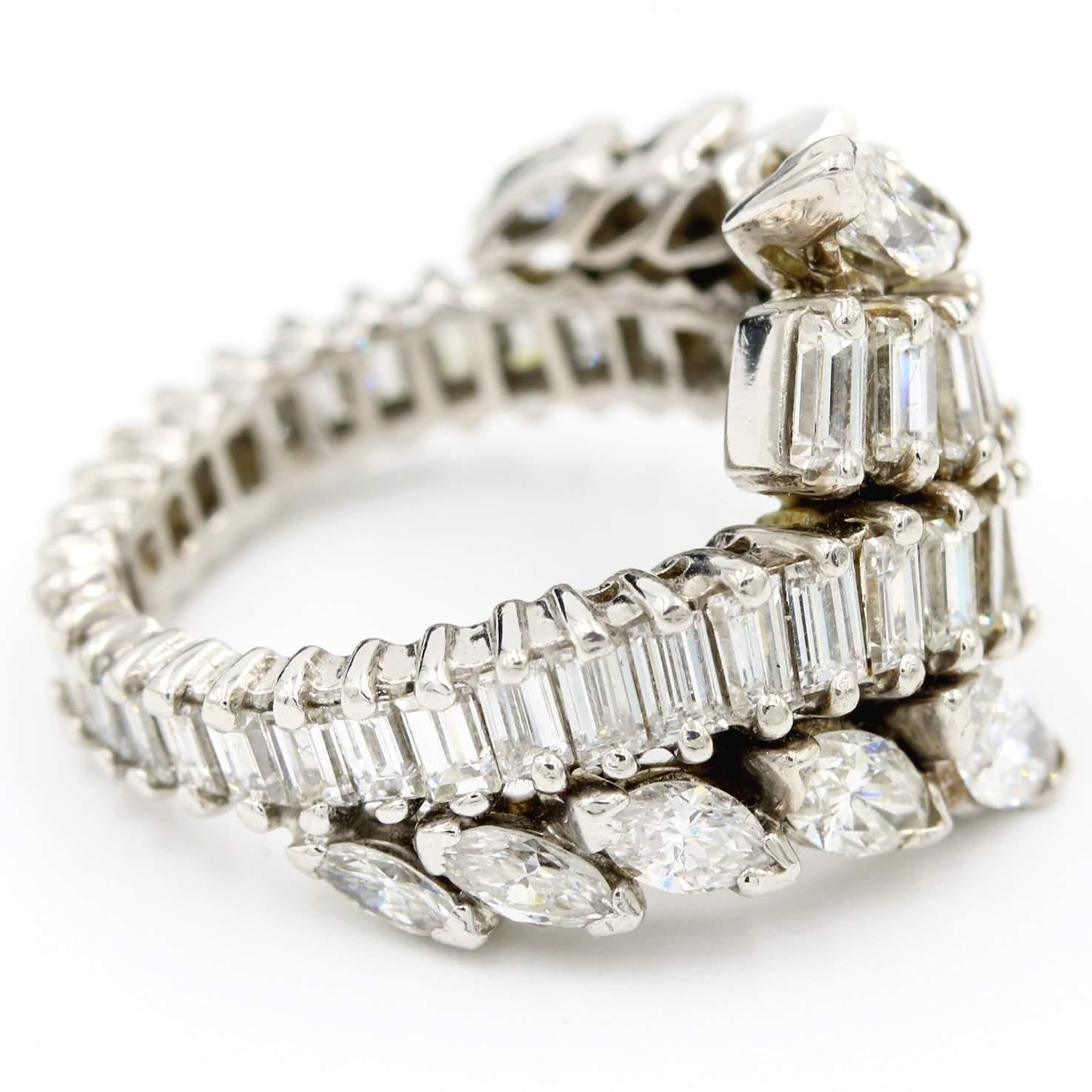 This platinum ring has 4.00 carat total weight of diamonds with a row of baguette diamonds that bypass each other on the front of the ring and 10 marquise diamonds. The diamonds are H in color and SI in clarity. This ring is a size 4.75.