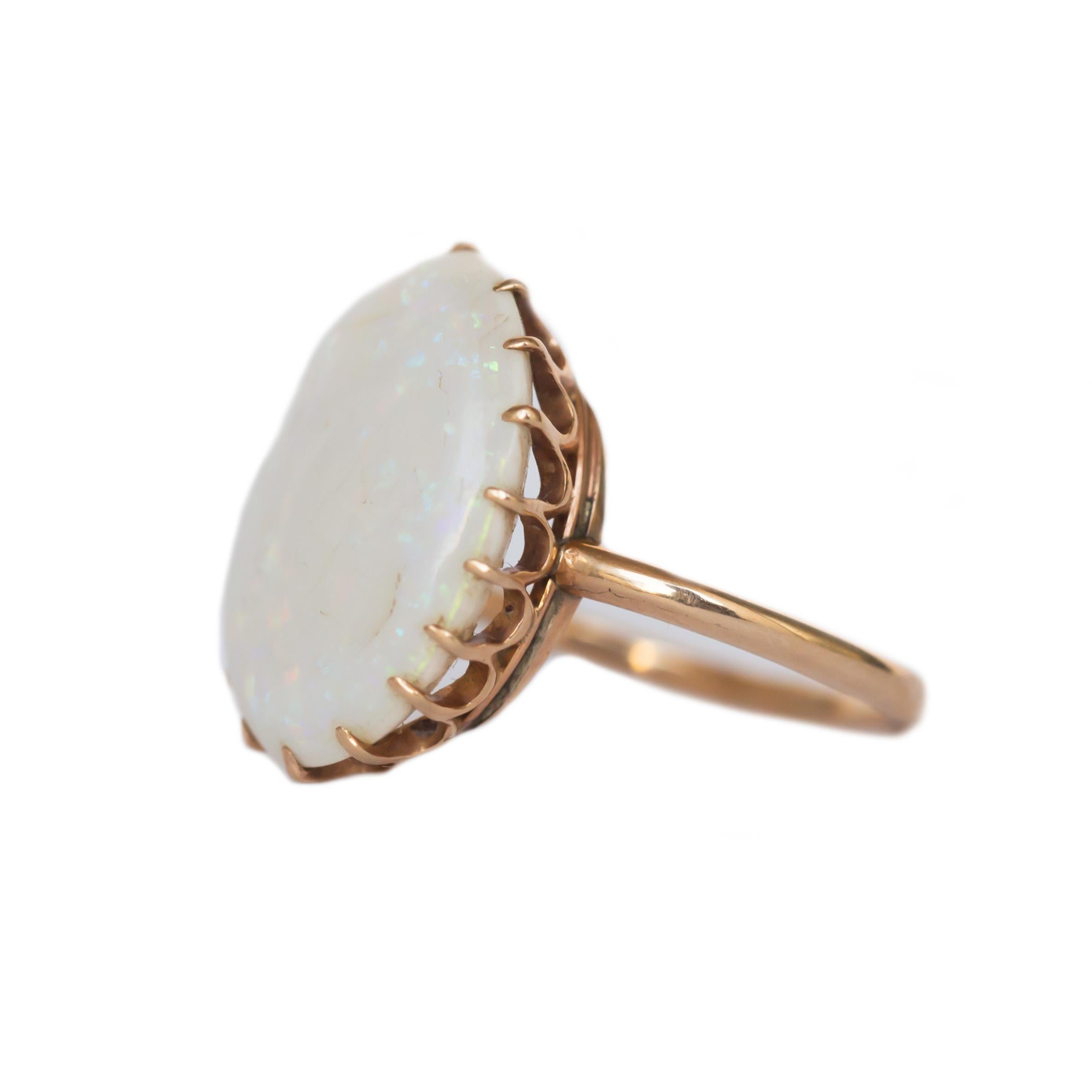 Ring Size: 5
Metal Type: 14 karat Rose Gold [Tested]
Weight: 3.0 grams

Color Stone Details: 
Type: Opal
Shape: Oval Cabachon
Carat Weight: 4 carat, total weight.
Color: White with Rainbow Color Play

Finger to Top of Stone Measurement: