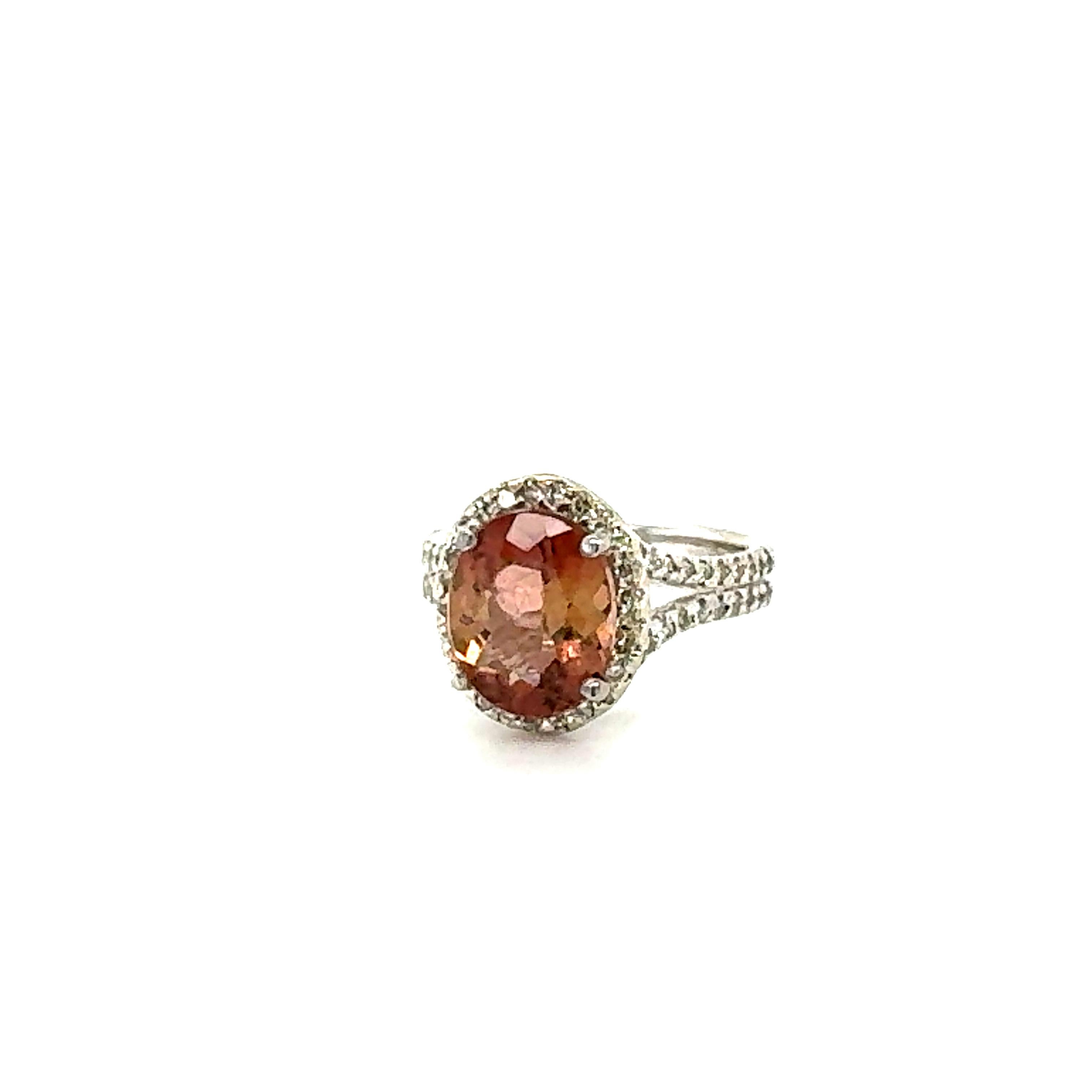 Super gorgeous 4.00 Carat Dual Color Tourmaline and Diamond 14K White Gold Cocktail Ring!

This ring has a 3.49 carat Oval Cut Dual Color Tourmaline that is set in the center of the ring and is surrounded by a Halo of 40 Round Cut Diamonds that