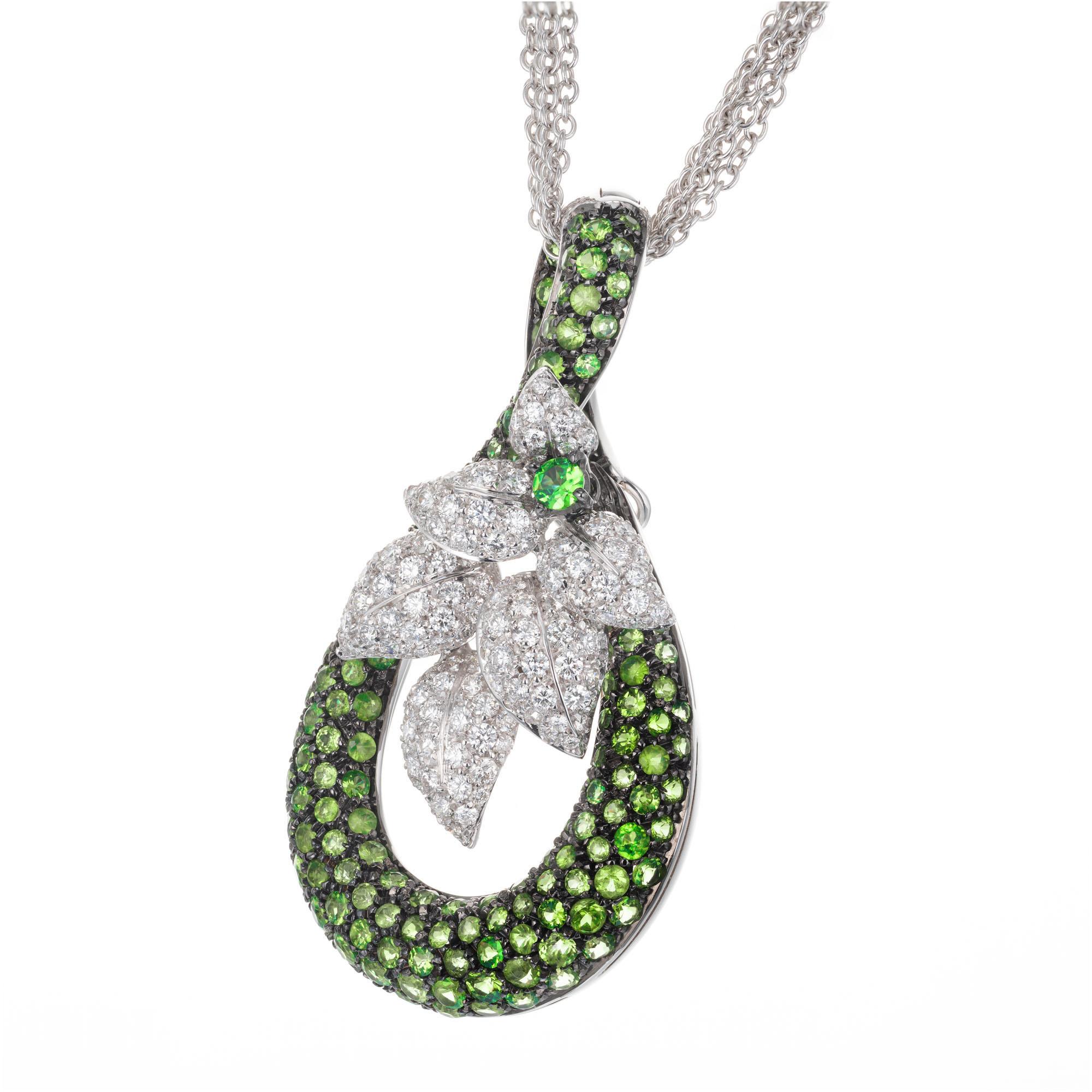 Swirl and flower design tsavorite garnet and diamond pendant enhancer necklace. 18k white gold multi strand necklace. 

155 green tsavorite garnet MI, approx. 4.00cts
136 round brilliant cut diamonds G VS-SI, approx. 2.35cts
18k white gold 
Stamped: