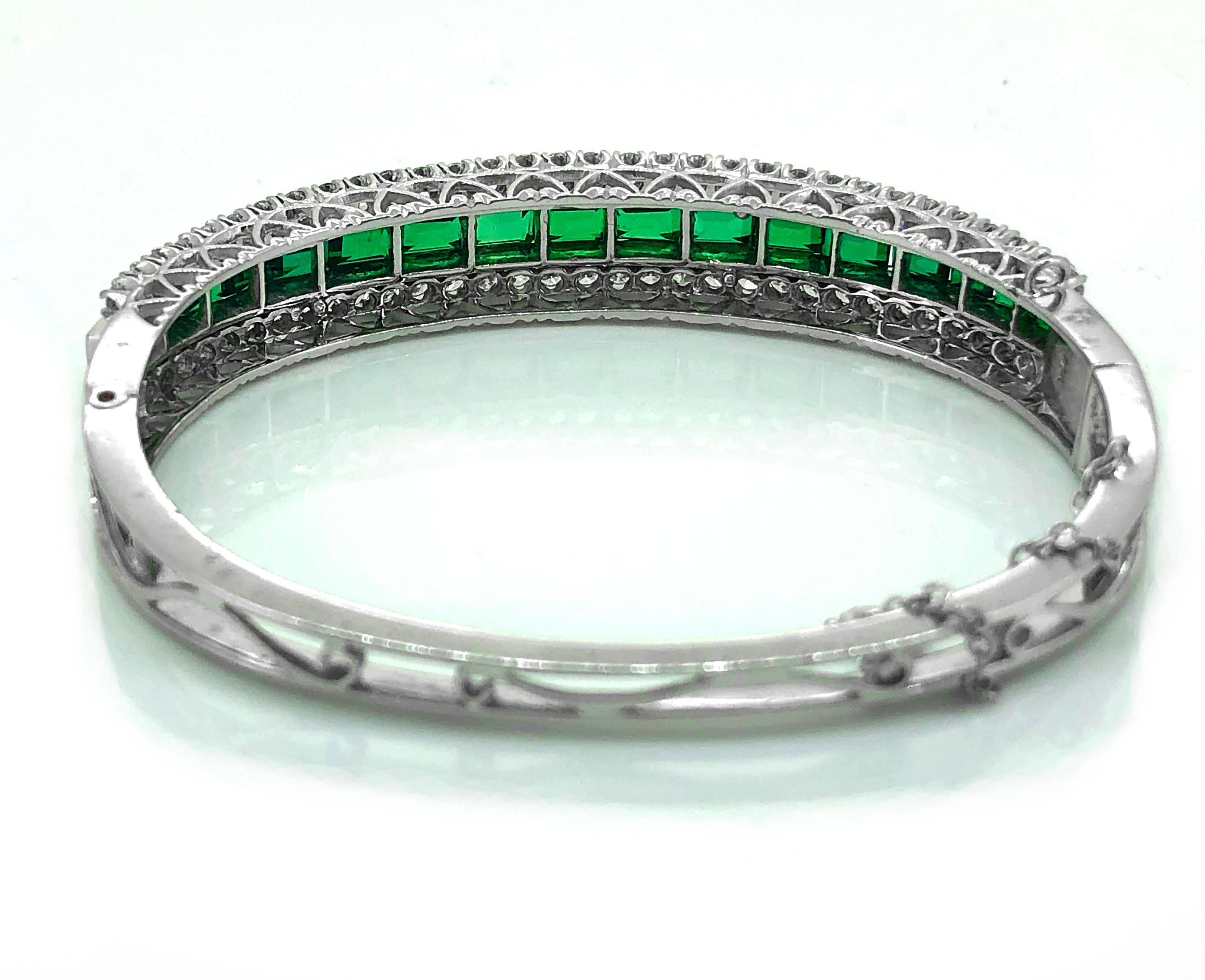 An exceptional garnet doublet and diamond Estate bangle bracelet featuring 4.00ct. Apx. T.W. of green garnet and rectangular step cut doublets and 2.00ct. Apx. T.W. of round brilliant diamonds with VS1-VS2 clarity and G-H color. A bold and striking