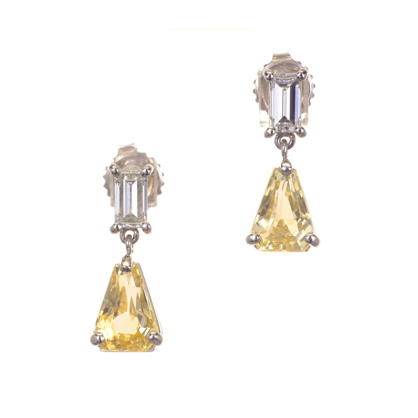 Natural no heat shield shape sapphires and baguette diamond dangle earrings. GIA certified sapphires, soft yellow in color. Set in platinum with two baguette accent diamonds.

1 Shield Cut Yellow Sapphire Approx. Total Weight 1.88cts GIA Certified