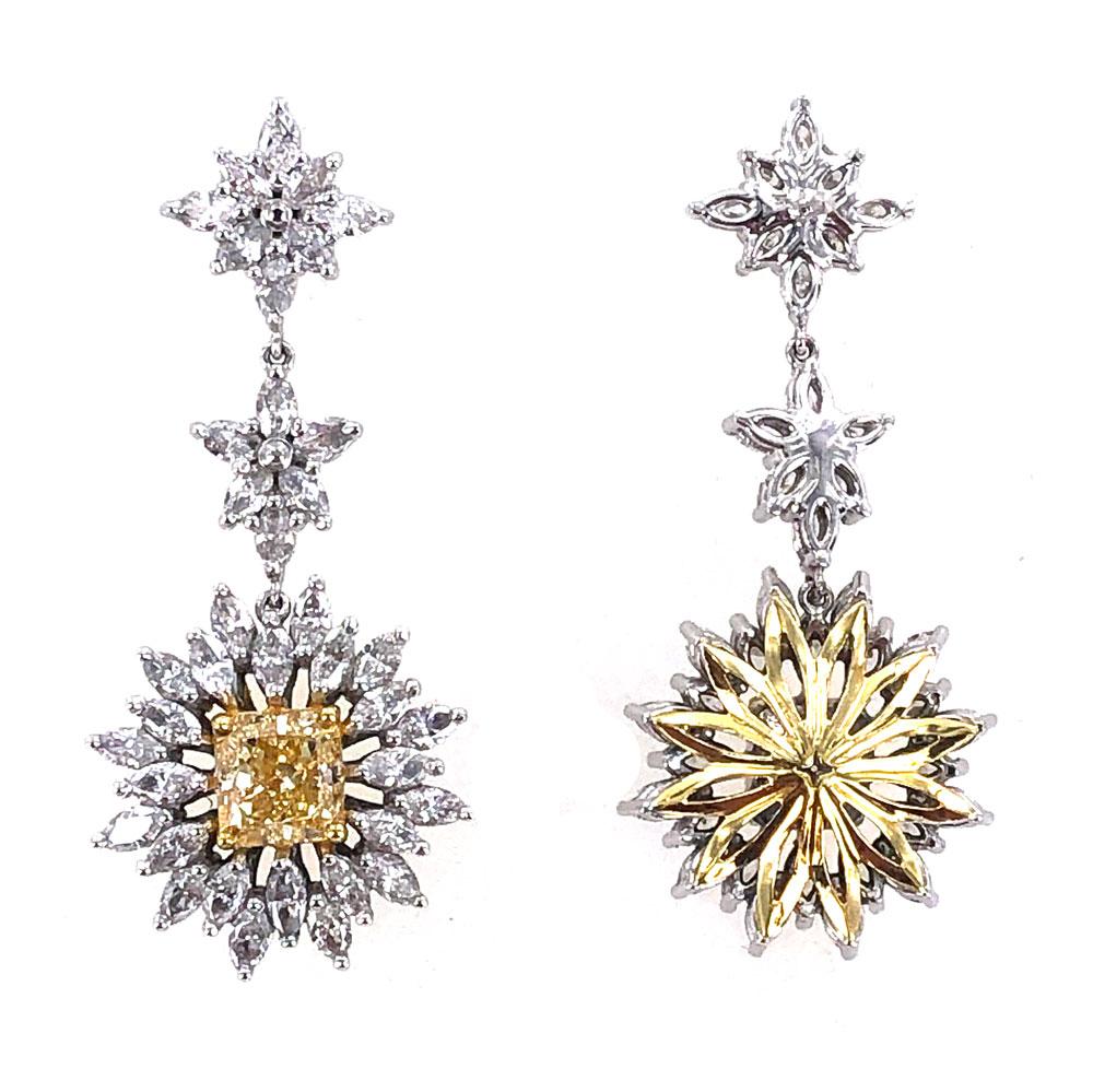 Stunning yellow and white diamond drop earrings. The drops feature fancy yellow (1.11 carat) and fancy light yellow (.90 carat ) princess cut diamonds graded by the GIA. The surrounding 74 marquise shape diamonds equal approximately 2.00 carat total