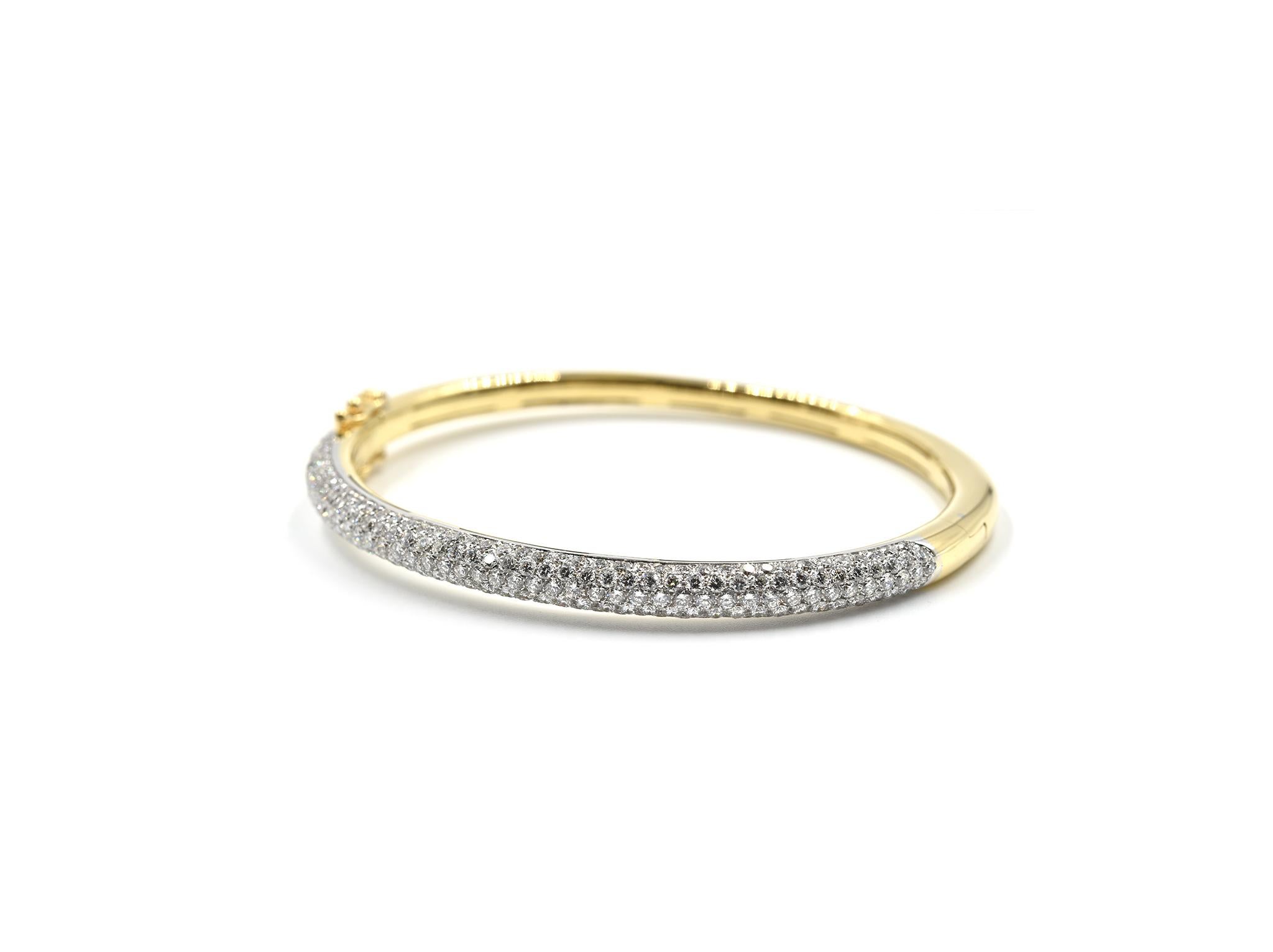 Designer: custom design
Material: 18k yellow gold
Diamonds: 4.00 carats total weight
Color: G
Clarity: VS
Dimensions: bangle will fit 6 1/4-inch wrist and is 1/8-inch wide 
Weight: 18.01 grams
