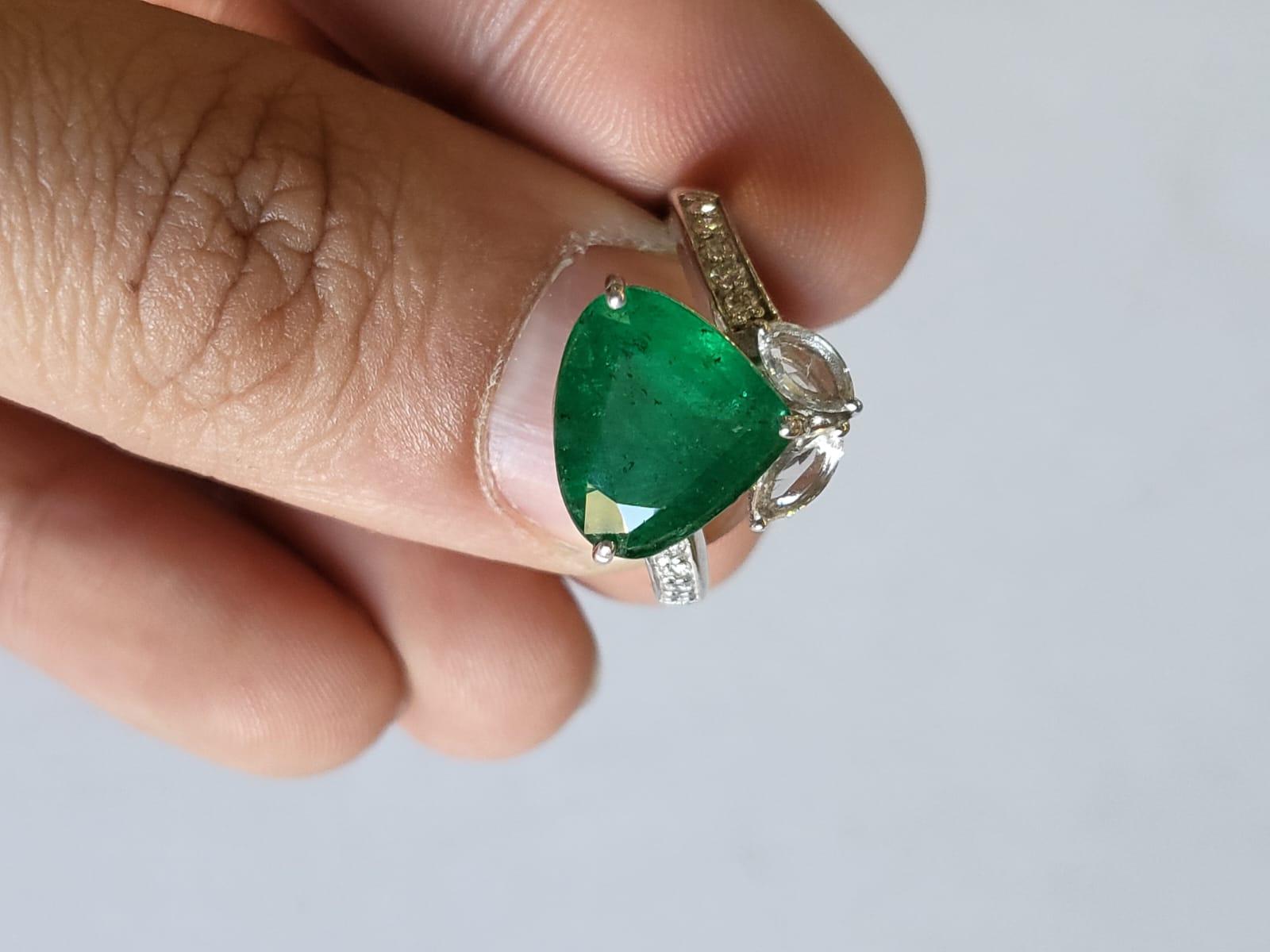 A very gorgeous and one of a kind, Emerald Engagement / Cocktail Ring set in 18K White Gold & Diamonds. The weight of the Emerald is 4.00 carats. The Emerald is completely natural without any treatment and is of Zambian origin. The combined weight