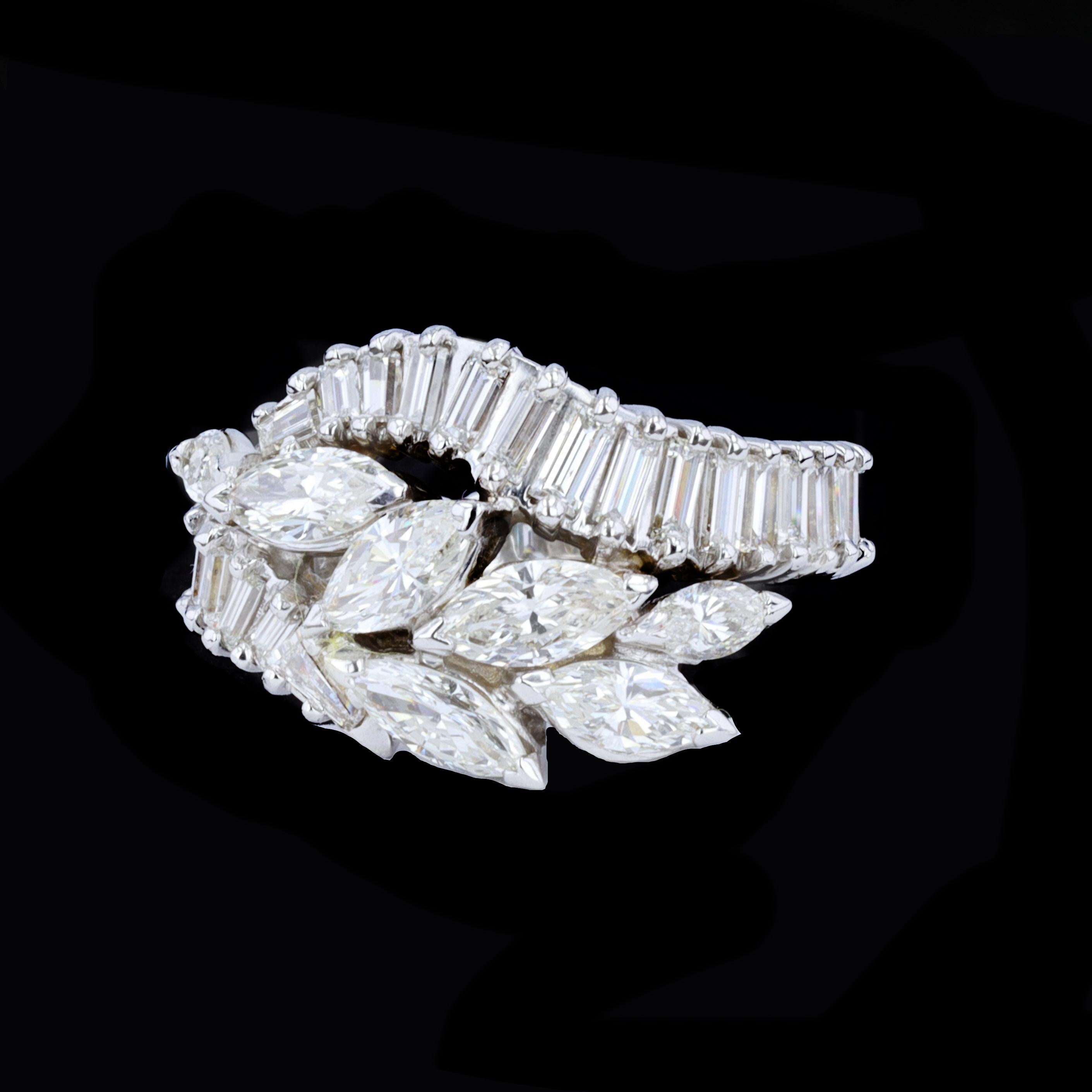 Let a wave of desire wash over you with this shimmering fluid platinum diamond cocktail ring. The ring is set with a sparkling cascade of marquise and baguette cut diamonds that weigh approximately 4.00ct. 

The color of these diamonds is H-I with