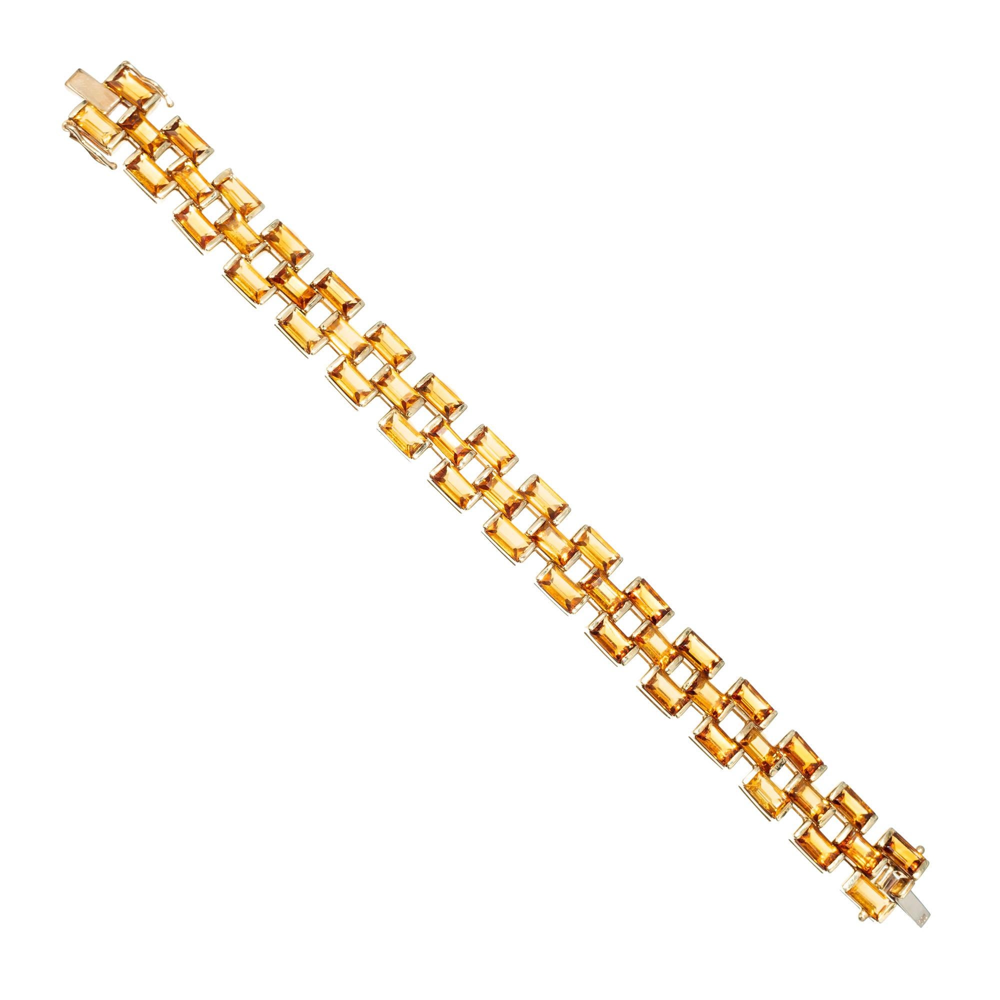 Three row citrine flexible bracelet. Set with 47 golden natural slightly orange yellow Citrines. 40.00ct total.
   
47 Emerald cut orangy yellow Citrines 7 x 4mm, approx. total weight 40.00cts    
Width: 13.4mm or .51 inch    
Depth: 4.65mm    
37.5