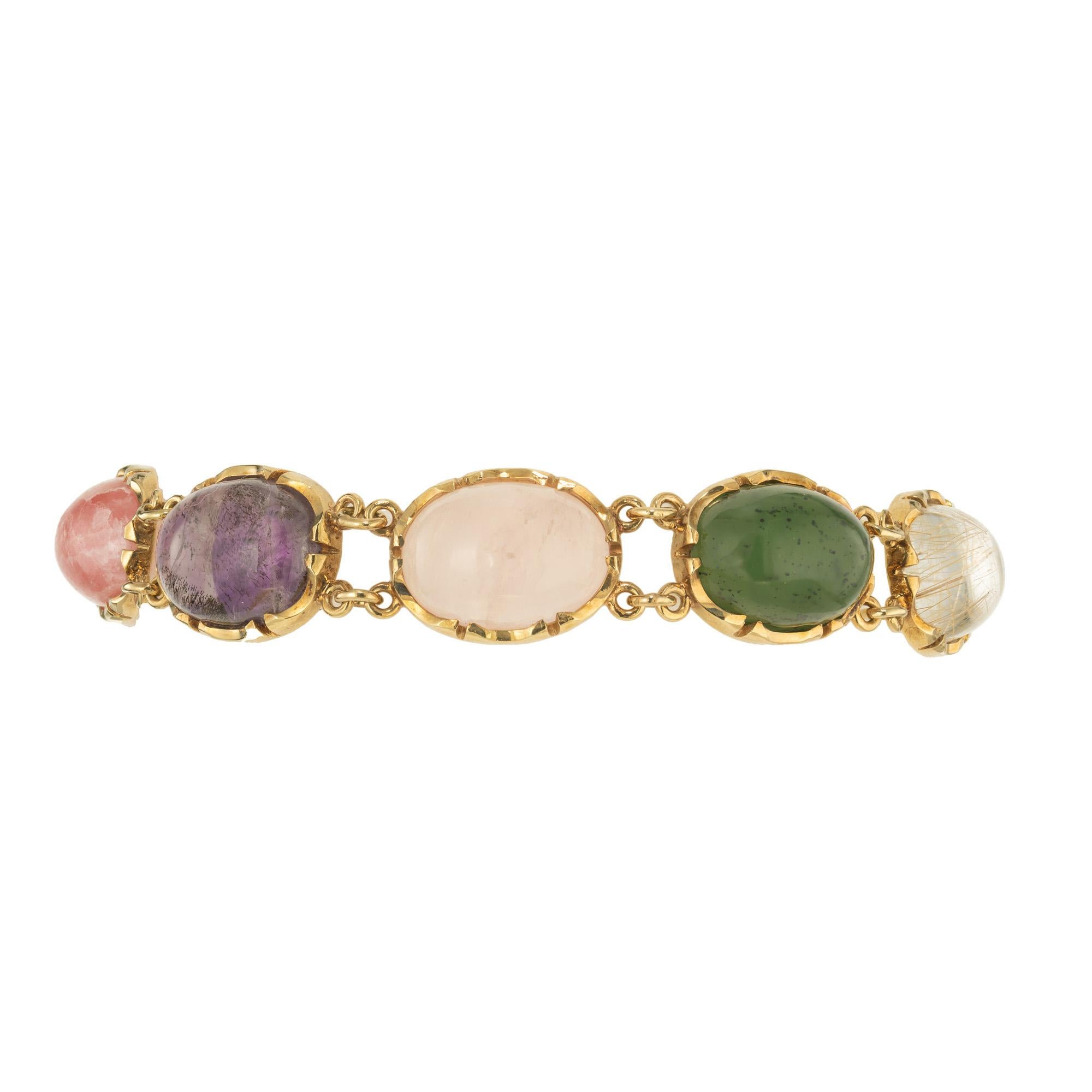 1950's Handmade link multi color stone 14k yellow gold Link bracelet with a collection of 10 oval cabochon all natural Quartz. Tiger eye, amethyst, rose quartz, aventurine, and rutilated quartz. The wonderful variety of hues of the gemstones blend