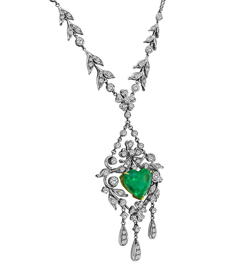 This is an elegant 18k white and yellow gold necklace. The necklace features lovely heart shape Colombian emerald that weighs approximately 4.00ct. The emerald is accentuated by sparkling round cut diamonds that weigh approximately 2.50ct. The color