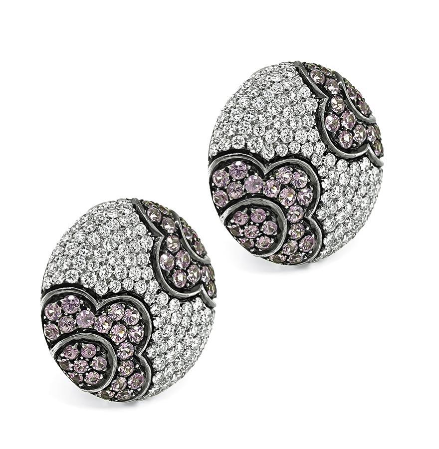 This is a magnificent pair of 18k white gold earrings. The earrings feature sparkling round cut diamonds and pink sapphires that weigh approximately 4.00ct and 4.00ct. The color of the diamonds is F with VS clarity. The earrings measure 24mm in