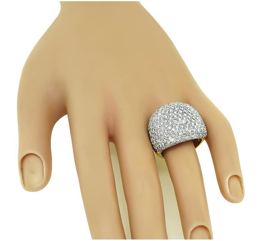 This is a fabulous 18k yellow and white gold cocktail ring. The ring is set with sparkling round cut diamonds that weigh approximately 4.00ct. The color of the diamonds is G-H with VS clarity. The ring has a tapering width from 6mm to 20mm. The ring