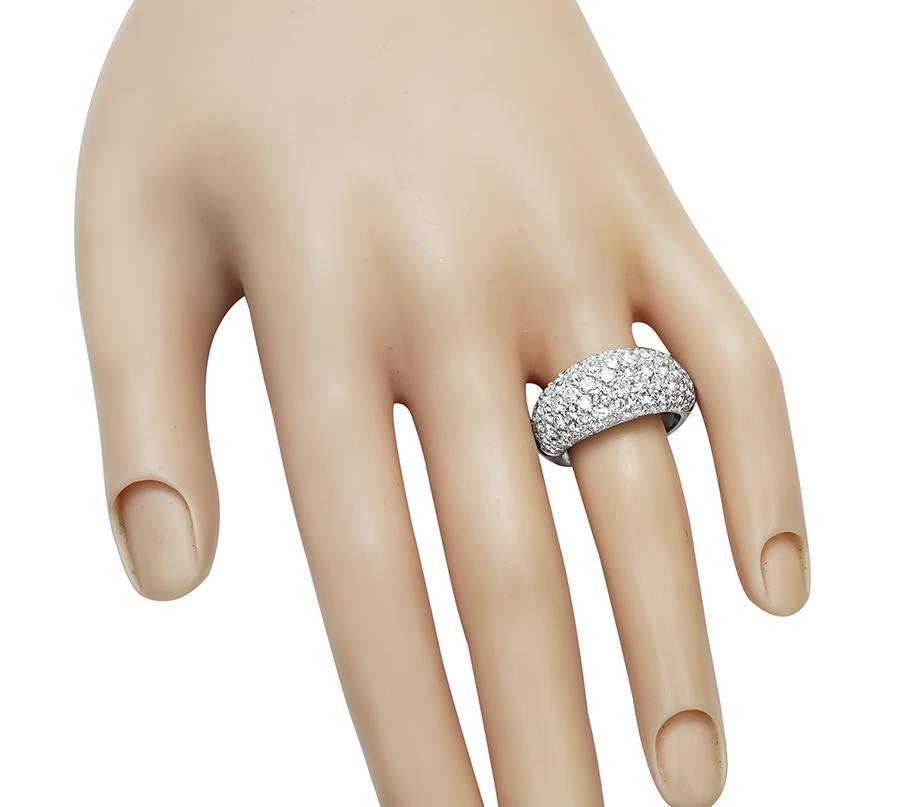 This is an elegant 18k white gold ring. The ring is set with sparkling round cut diamonds that weigh approximately 4.00ct. The color of these diamonds is G with VS clarity. The top of the ring measures 10mm by 23mm. The ring weighs 7.1 grams. The