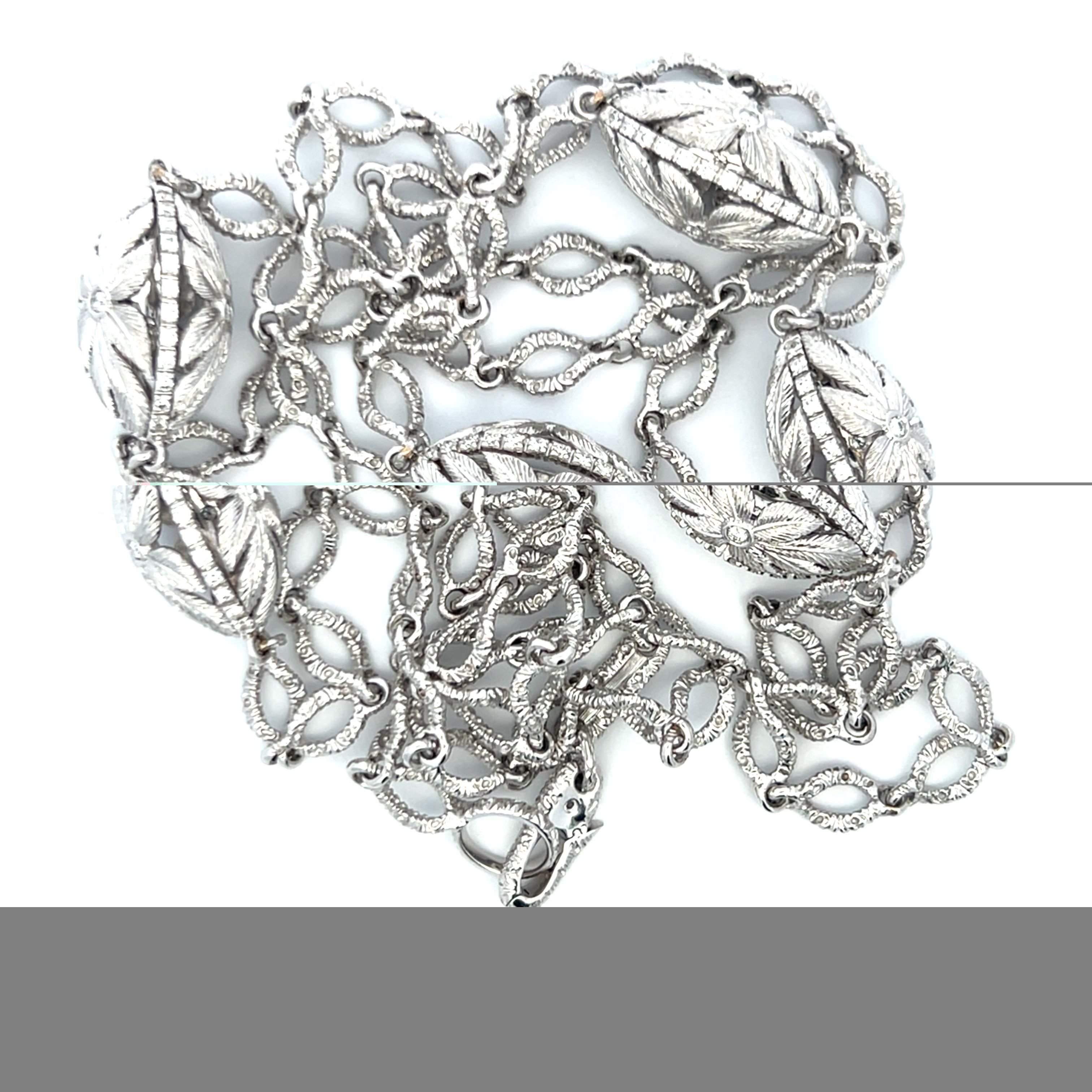 Title:
This exquisite 18K white gold necklace showcases a beautifully refined vintage aesthetic, featuring intricately sculpted leaf-motif links accented with approximately 4.00 carats of sparkling H-VS1 round brilliant diamonds. Each section is