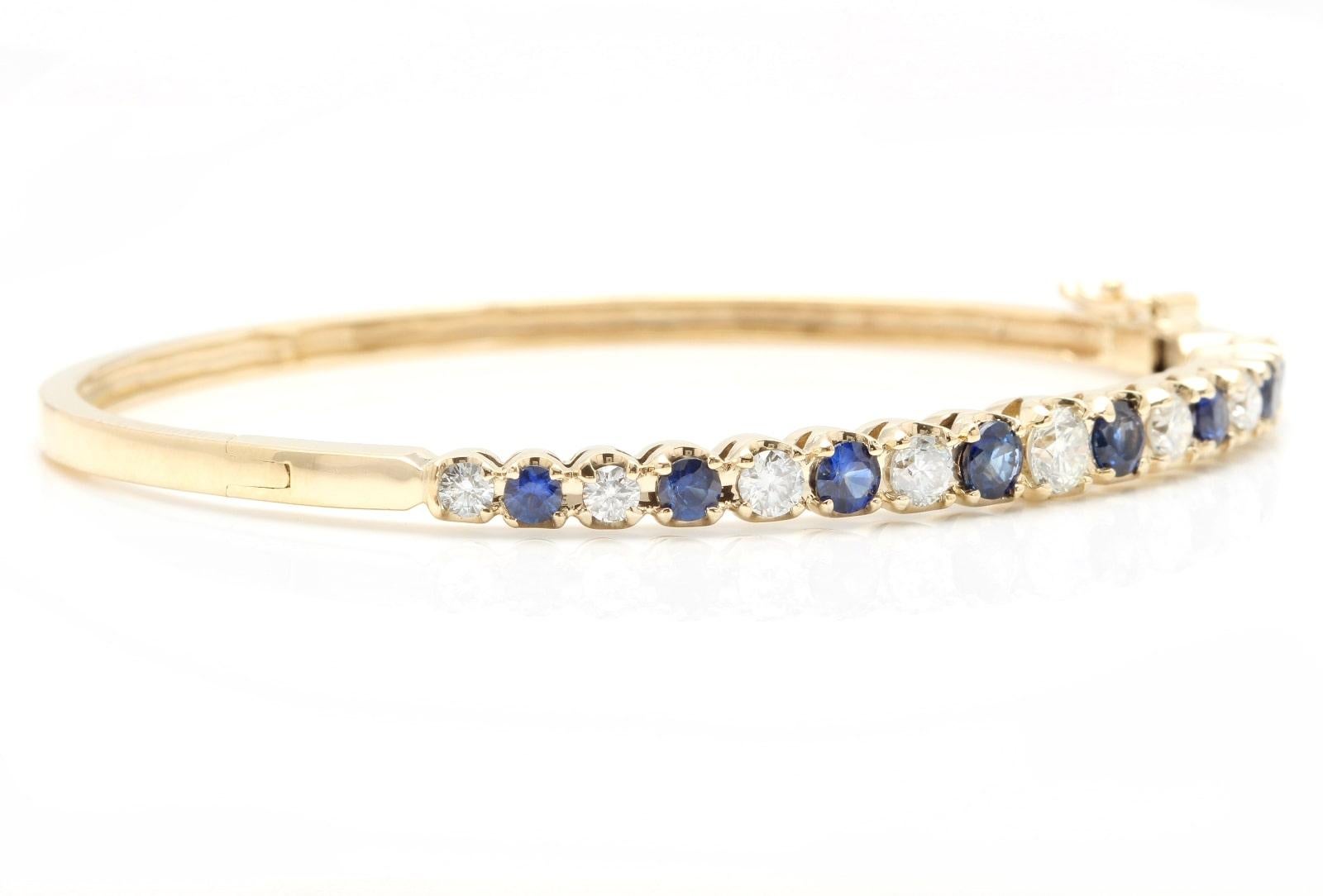 Very Impressive 4.00 Carats Natural Diamond and Sapphire 14K Solid Yellow Gold Bangle Bracelet 

Suggested Replacement Value: Approx. $9,000.00

STAMPED: 14K

Total Natural Round Diamonds Weight: Approx. 1.70 Carats (color G-H / Clarity SI1)

Center