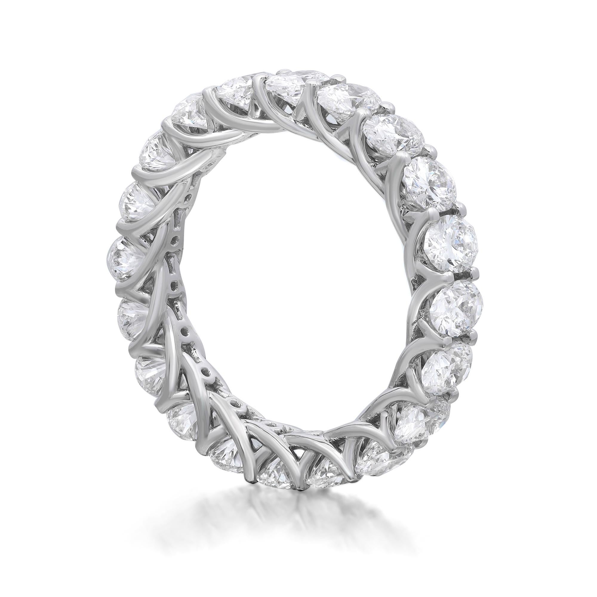 This diamond eternity band ring is a beautiful take on a classic style. It features 20 oval cut sparkling diamonds encrusted in prong setting. Crafted in fine 18K white gold. Total diamond weight: 4.00 carats. Diamond quality: color G-H and clarity