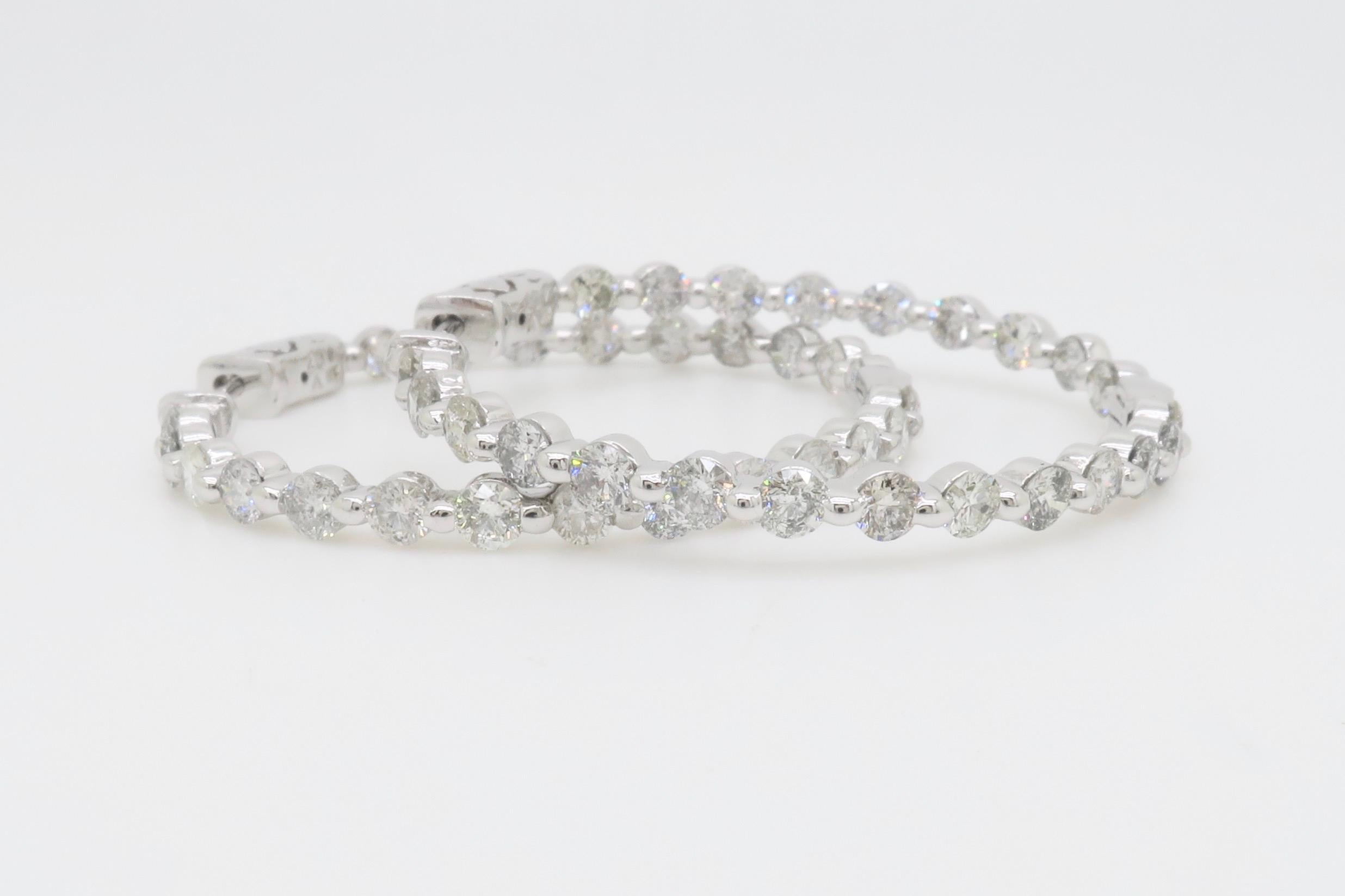 Beautiful pair of inside out diamond hoops made with 4.00ctw of Round Brilliant cut diamonds. 

Diamond Carat Weight: 4.00CTW
Diamond Cut: Round Brilliant Cut 
Color: F-H
Clarity: SI1-I1
Metal: 14K White Gold
Marked/Tested: Stamped “14K