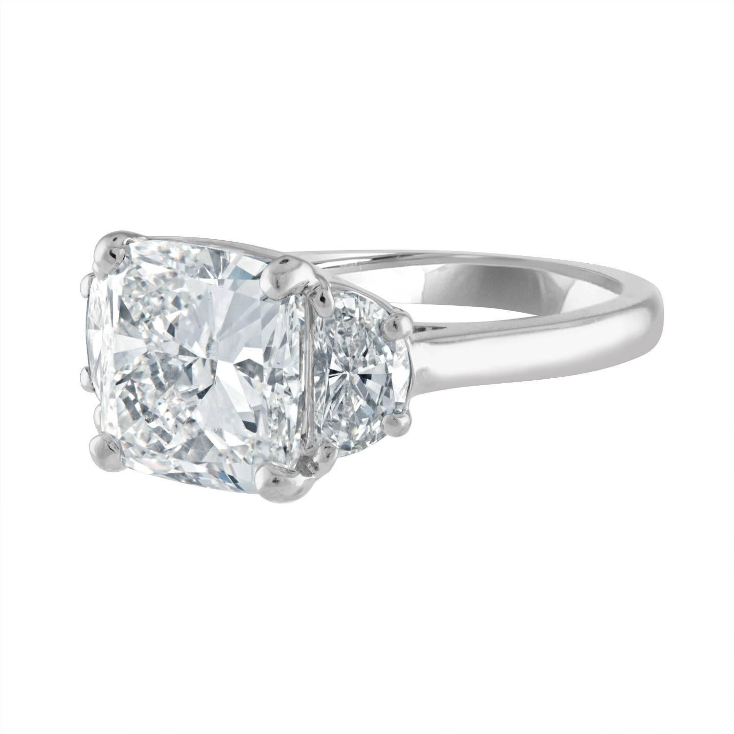 4.01 Carat Cushion Cut Diamond, Brilliant Diamond, is set in Hand Crafted Platinum Three Stone Ring Mounting. The Center is set with Two Half Moons Diamonds Weight 0.88 Carat Total Weight. The Half Moons are Estimated to be H in Color & SI in
