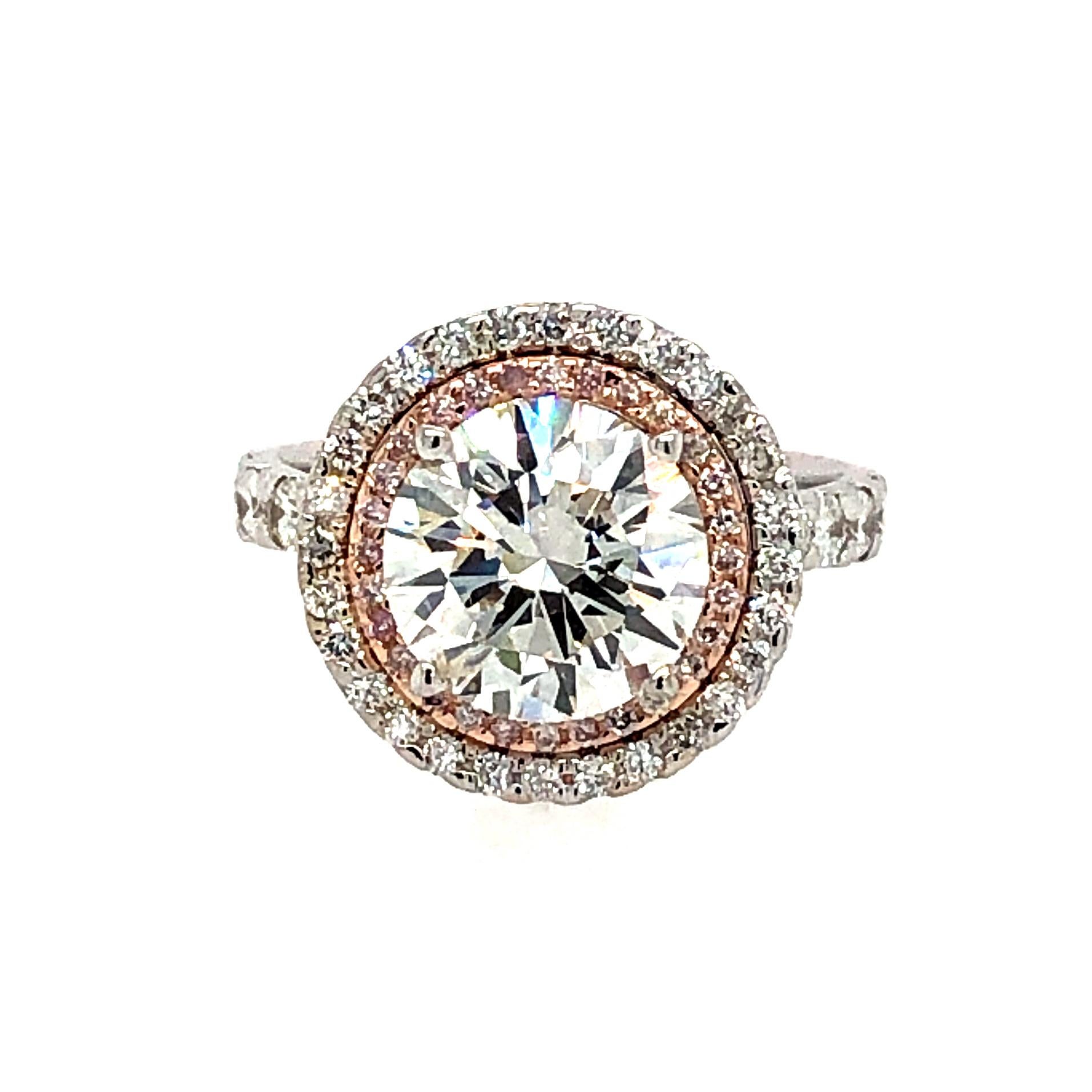 Offered here is a stunning diamond engagement ring set in 18kt two tone gold.
The center diamond is just breathtaking has lots of fire and brilliancy. The center diamond weighs 3.05 carat.
Diamond quality F-G color with fine Si2-Si3 clarity, set in