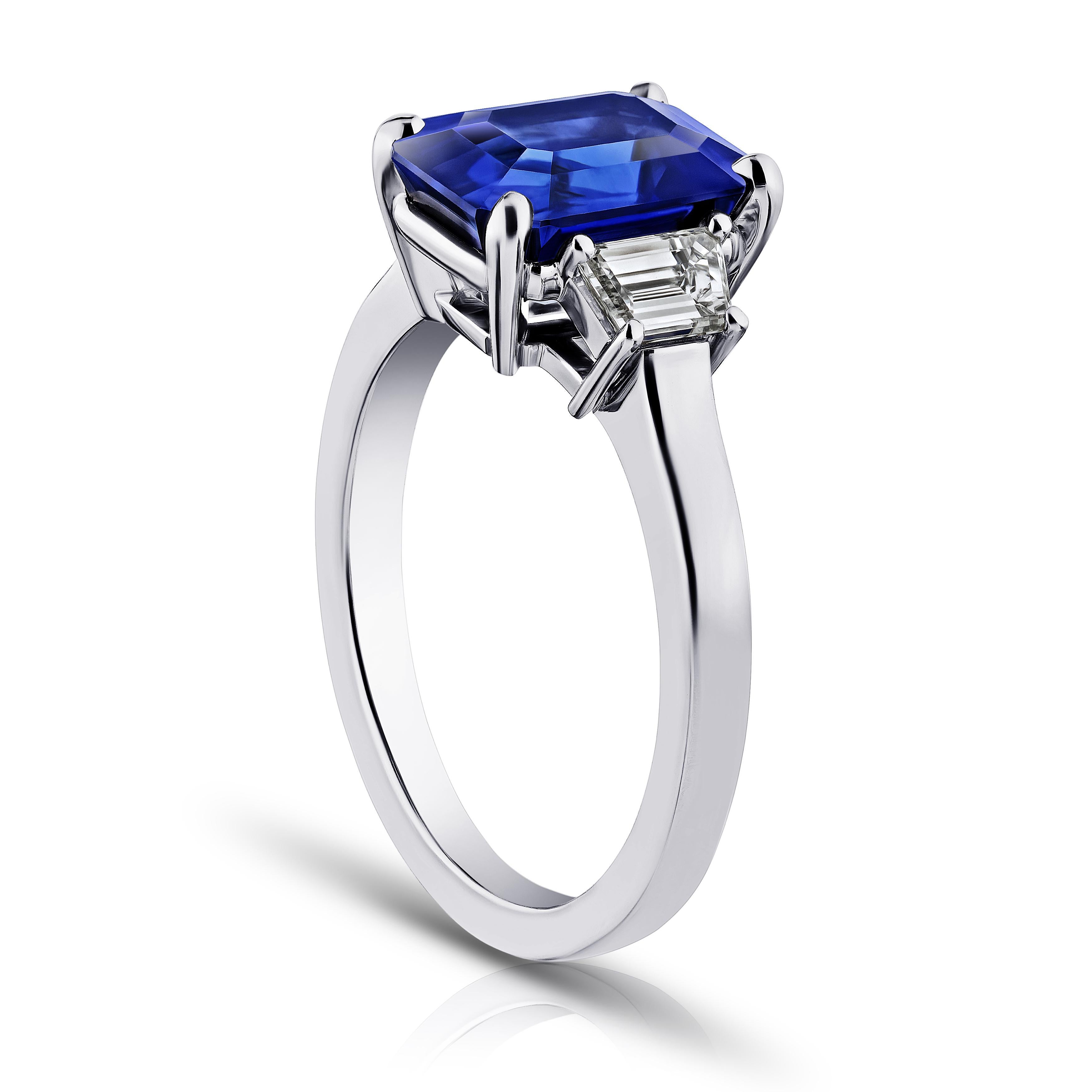 4.01 carat emerald cut blue sapphire with trapezoid diamonds .57 carats set in a platinum ring. Size 7. Free resizing included to your finger size.  