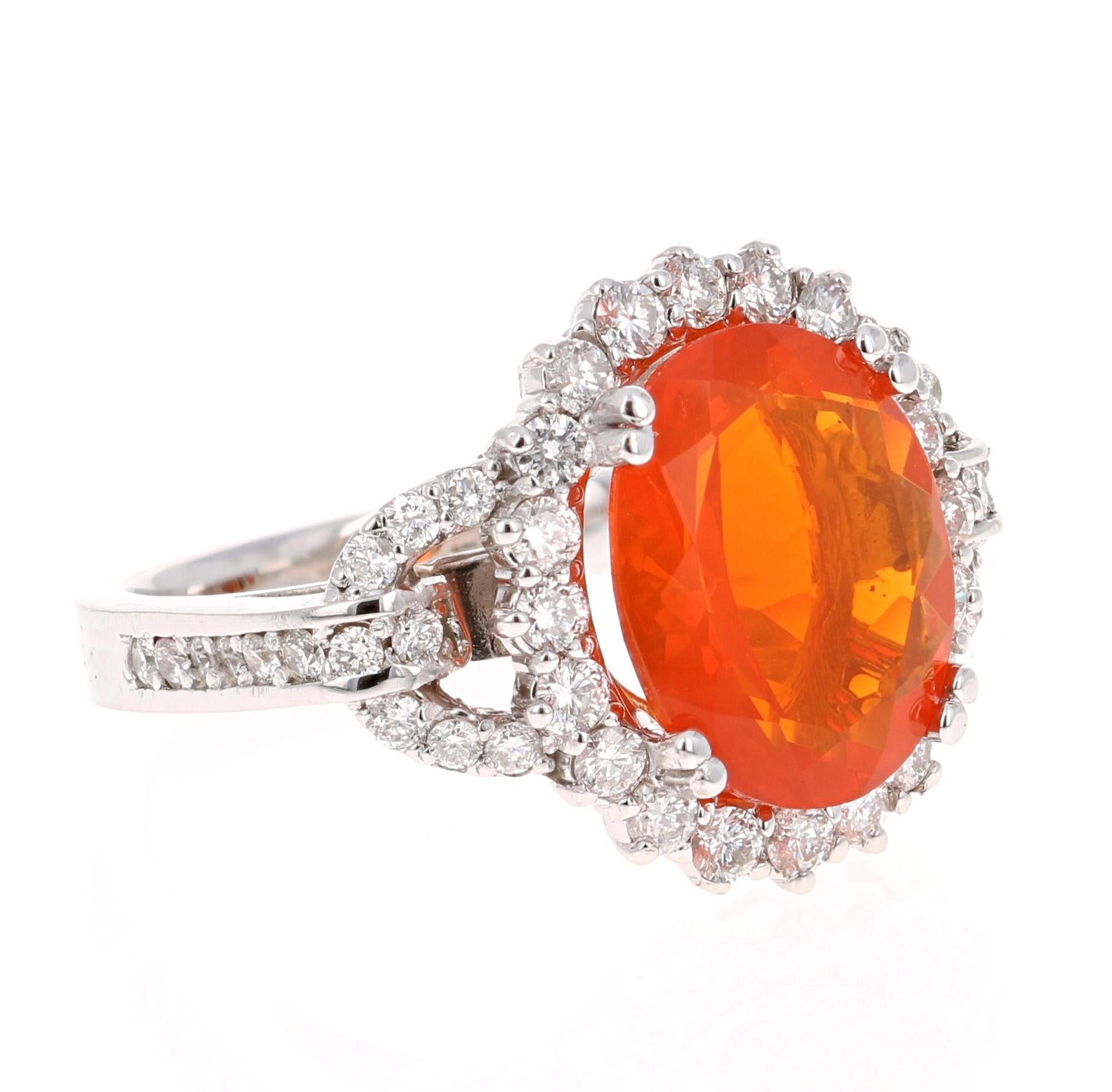 
The Orange Oval Cut Fire Opal weighs 3.05 Carats and has 48 Round Cut Diamonds that weigh 0.96 Carats. The clarity and color of the diamonds are SI-F. The total carat weight of the ring is 4.01 Carats. 

It is curated in 14K White Gold and is