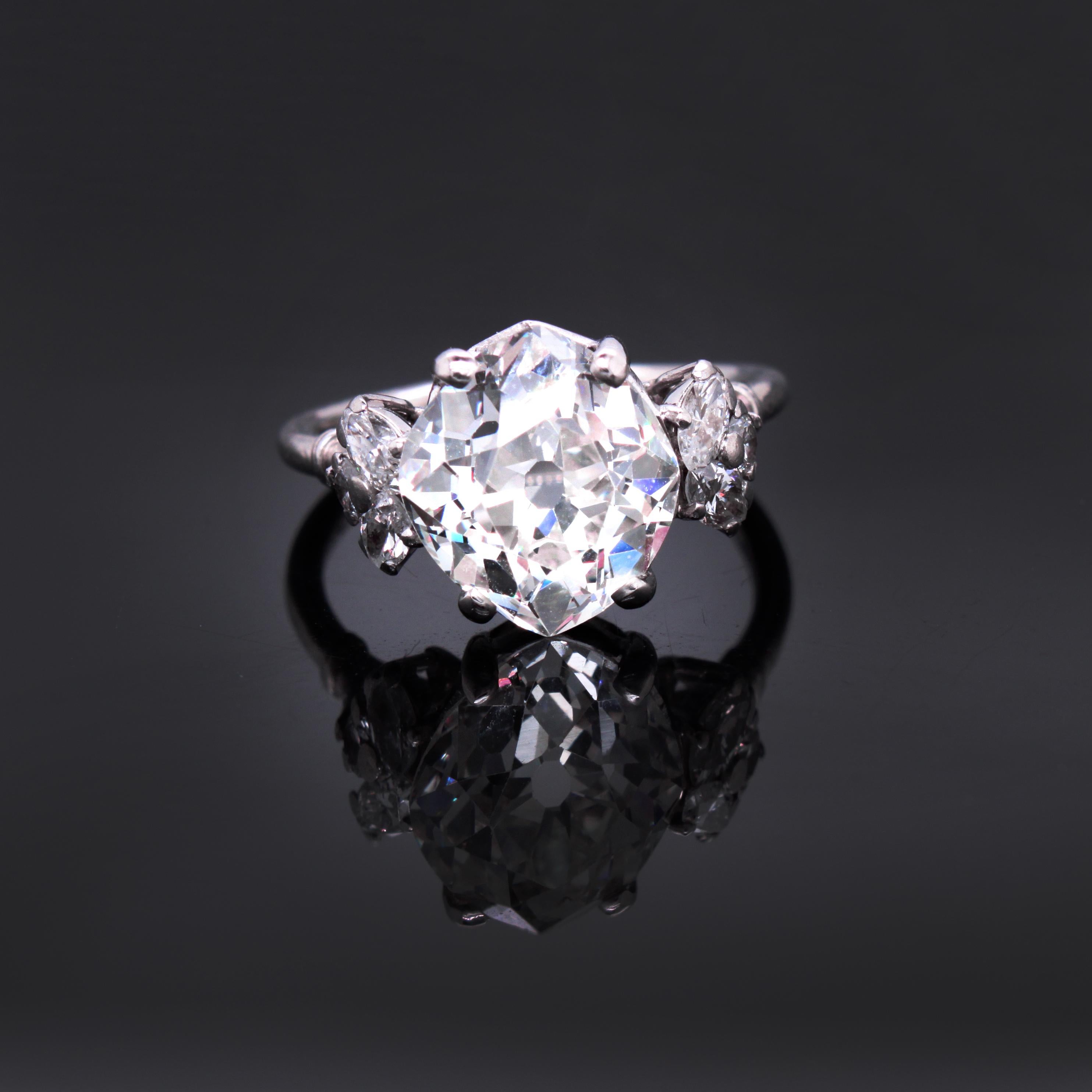 A Rare 4.01 carats Old Mine Cut Diamond Ring

The ring centres a beautiful and rare old-mine cut rhombus shaped diamond of 4.01 carats (ca. IJ/VS1). It is accented by marquise cut and round brilliant cut diamonds on the shoulders. 

The ring is made