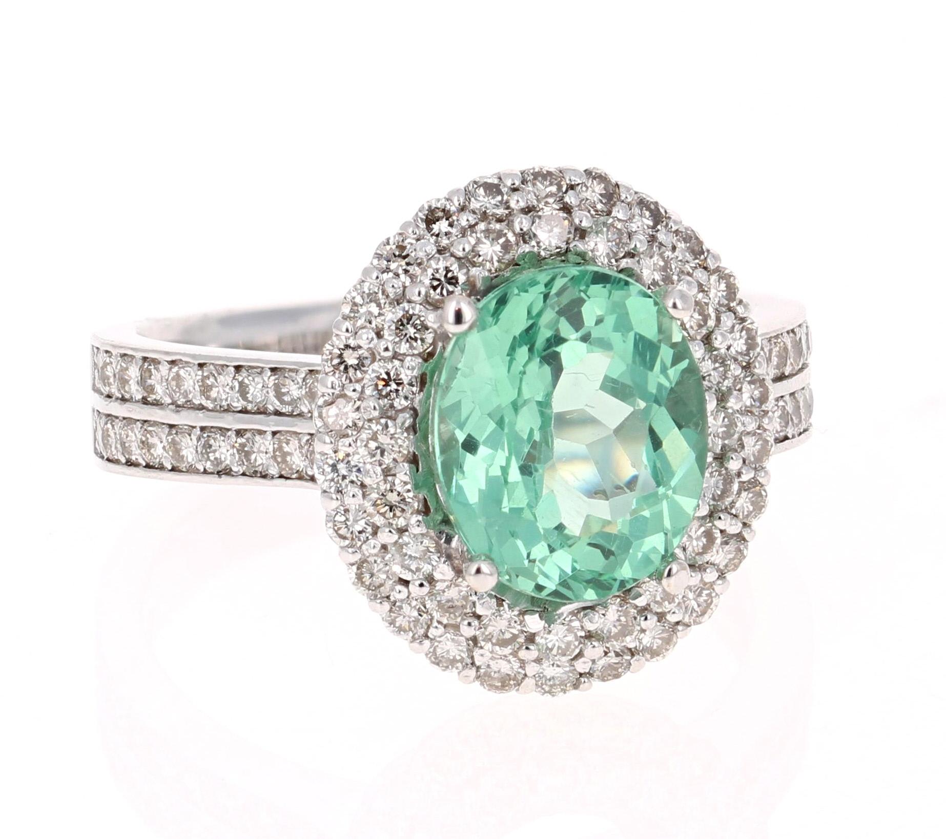 Gorgeous Double Halo Apatite and Diamond Ring.  This ring has an Oval Cut 2.95 carat Apatite in the center of the ring and is surrounded by a double halo of 82 Round Cut Diamonds that weigh 1.06 carat (Clarity: VS2, Color:F).  The total carat weight