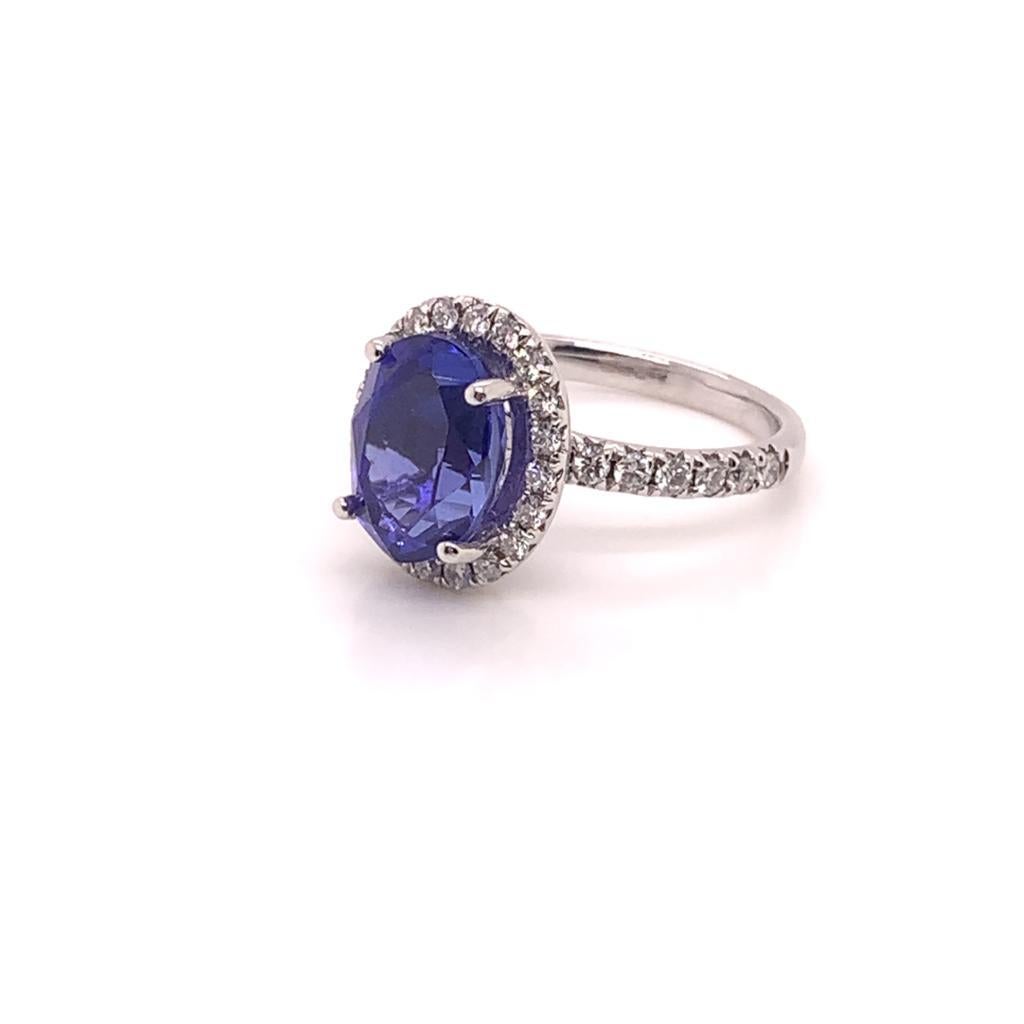 This beautifully crafted ring has an Oval cut Tanzanite weighing approximately 4.01 Carats at its centre. Surrounded by Round Brilliant Diamonds weighing approximately 0.62 Carats, the stunning stone is set in a Diamond encrusted band of 18k White