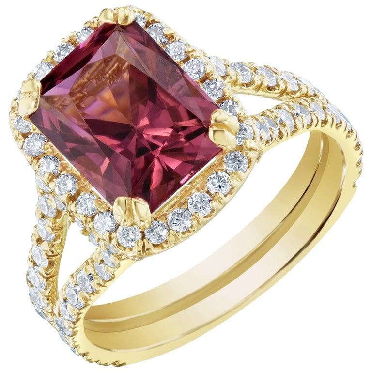 Stunning Dark Pink Tourmaline and Diamonds set in a spit-shank and halo setting. This ring has a 2.97 carat Rectangle Cut Tourmaline in the center of the ring and is surrounded by 92 Round Cut Diamonds that weigh 1.04 carats. The clarity and color