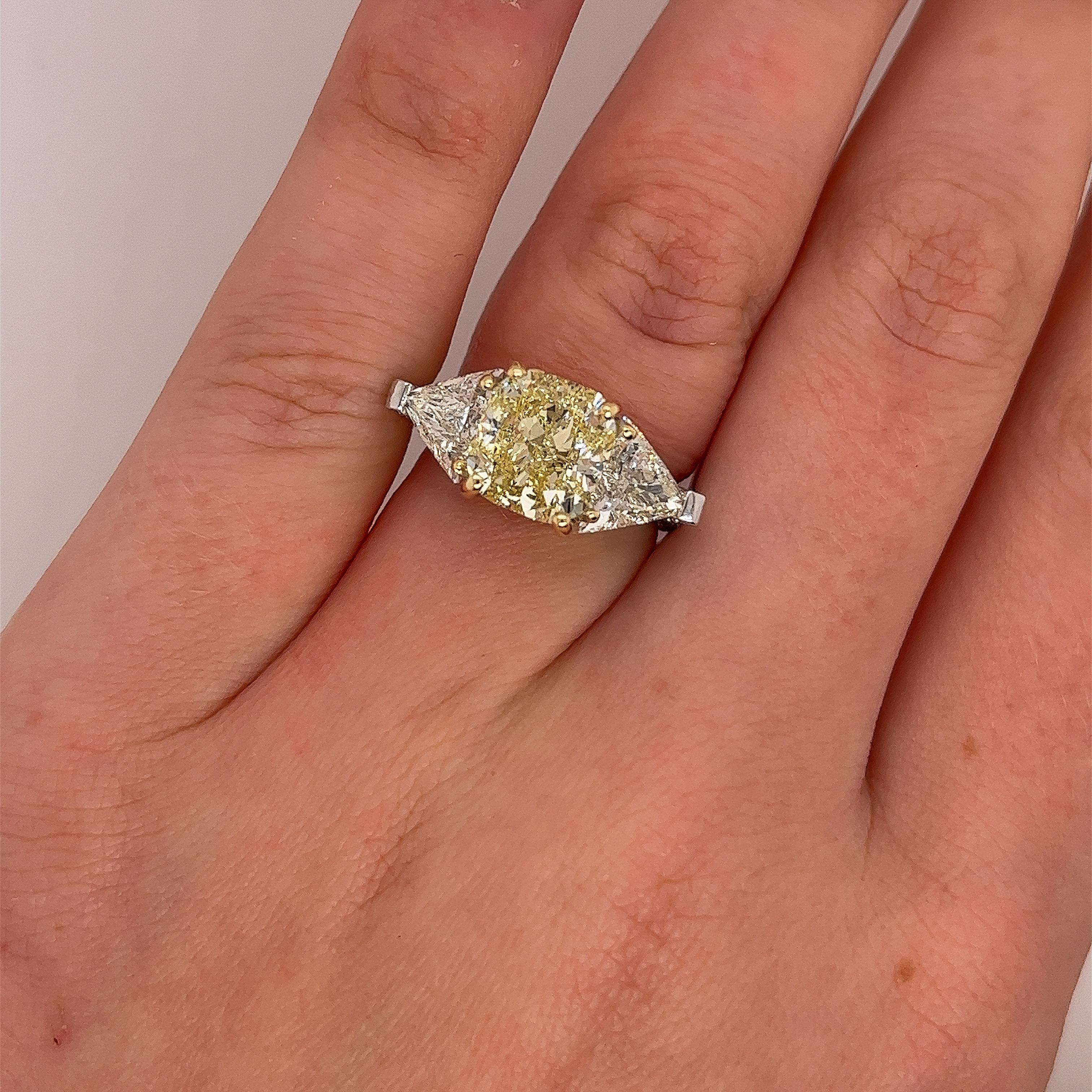 An elegant, unique 18ct white gold diamond ring for your engagement, 
set with 4.01ct fancy yellow colour and SI1 clarity GIA-certified
natural cushion cut diamond,
set with 2.20ct matching triangle diamonds on the sides 
and surrounded by 0.60ct