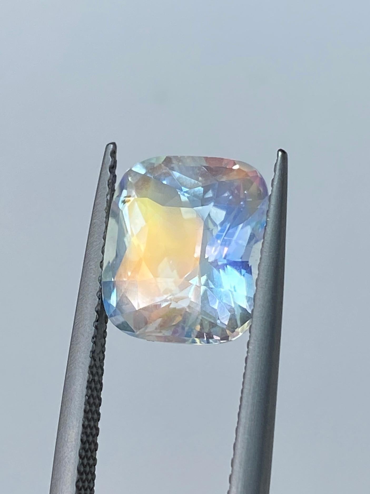 The Sapphire Merchant presents this exceptional Malagasy Rainbow Moonstone (Labradorite), a mesmerising natural gemstone that exhibits a unique and visually stunning play on colour. With a generous weight of 4.01 carats and a popular cushion shape
