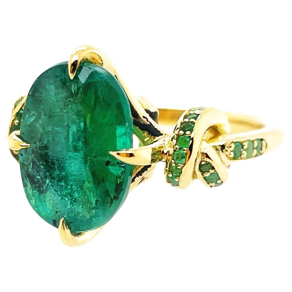 4.01ct Oval Cut Emerald Forget Me Knot ring with Emeralds in 18ct yellow gold For Sale