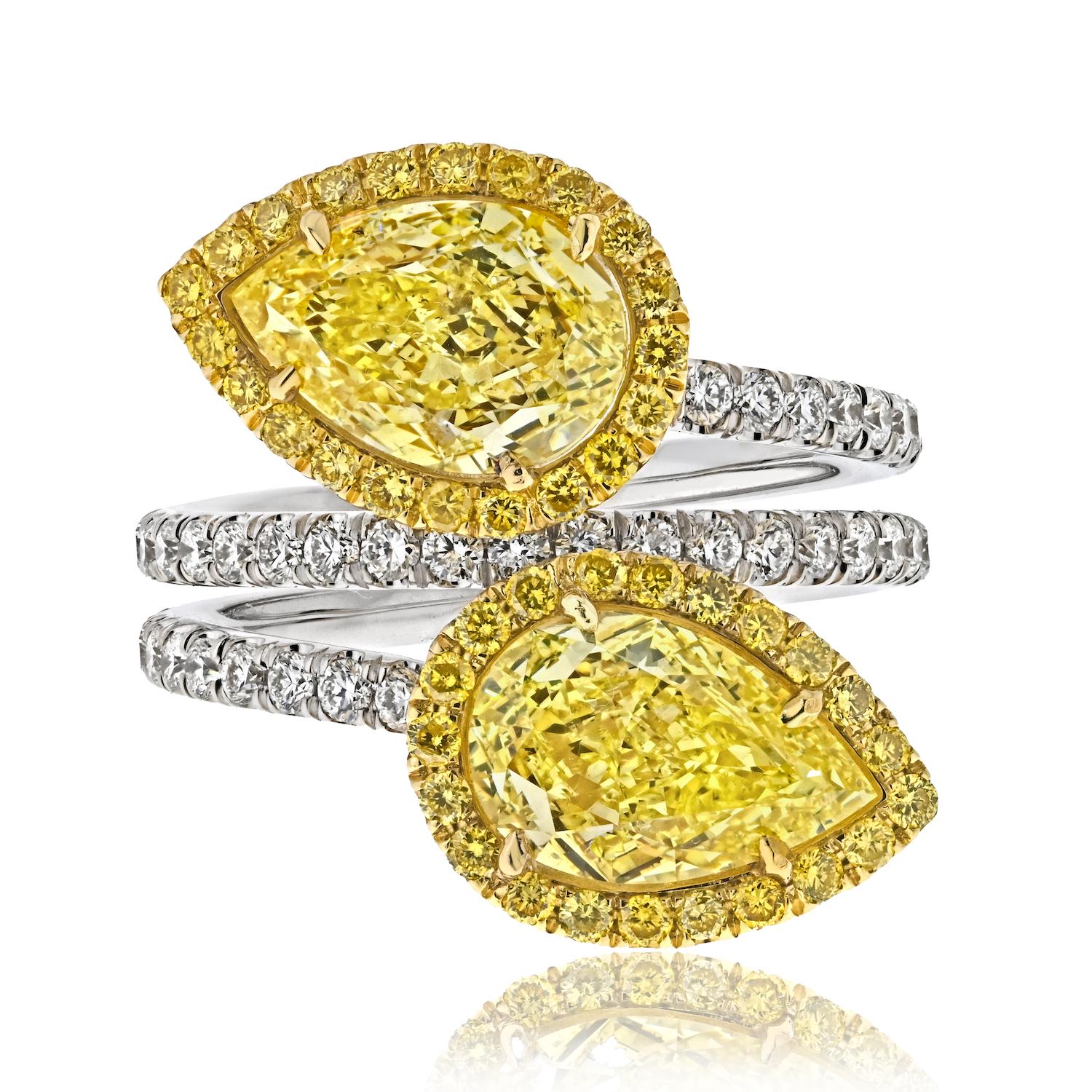 Experience the exquisite union of elegance and love with our Twogether Two Stone Pear Cut Diamond Ring, a celebration of two hearts coming together as one. This exceptional ring features two magnificent GIA certified pear-shaped fancy yellow intense