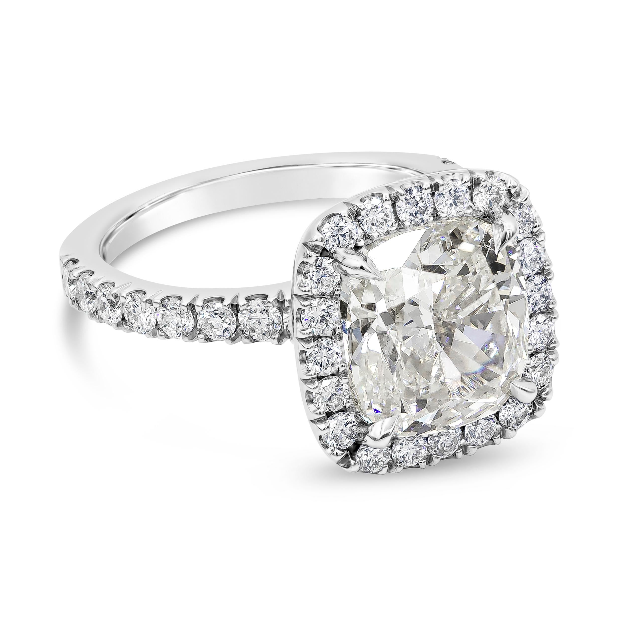 A contemporary piece of jewelry showcasing a 4.02 carat cushion cut diamond, surrounded by round brilliant diamonds in a polished platinum mounting. GIA certified the center diamond as J color, VS2 clarity. Accent diamonds weigh 0.98 carats total.
